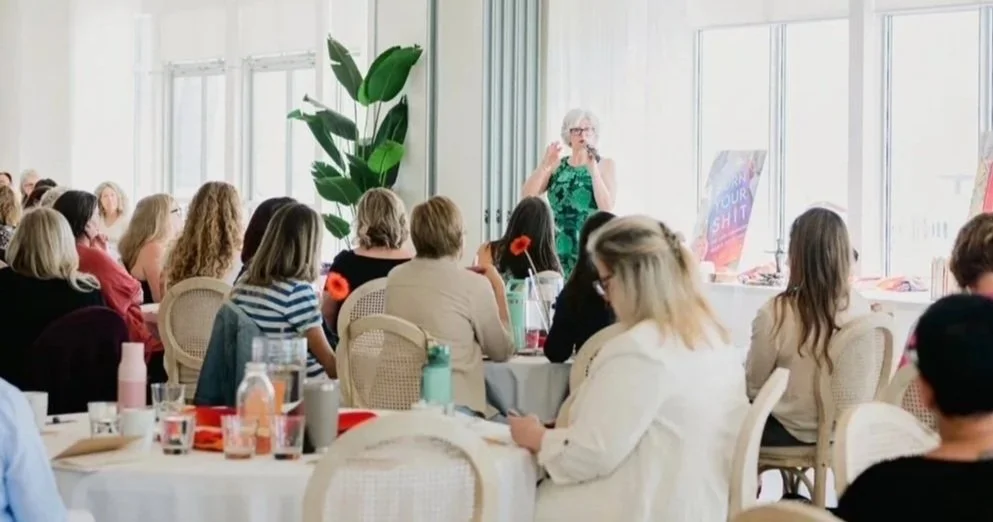 Lori Dyan speaking to an audience at a corporate event