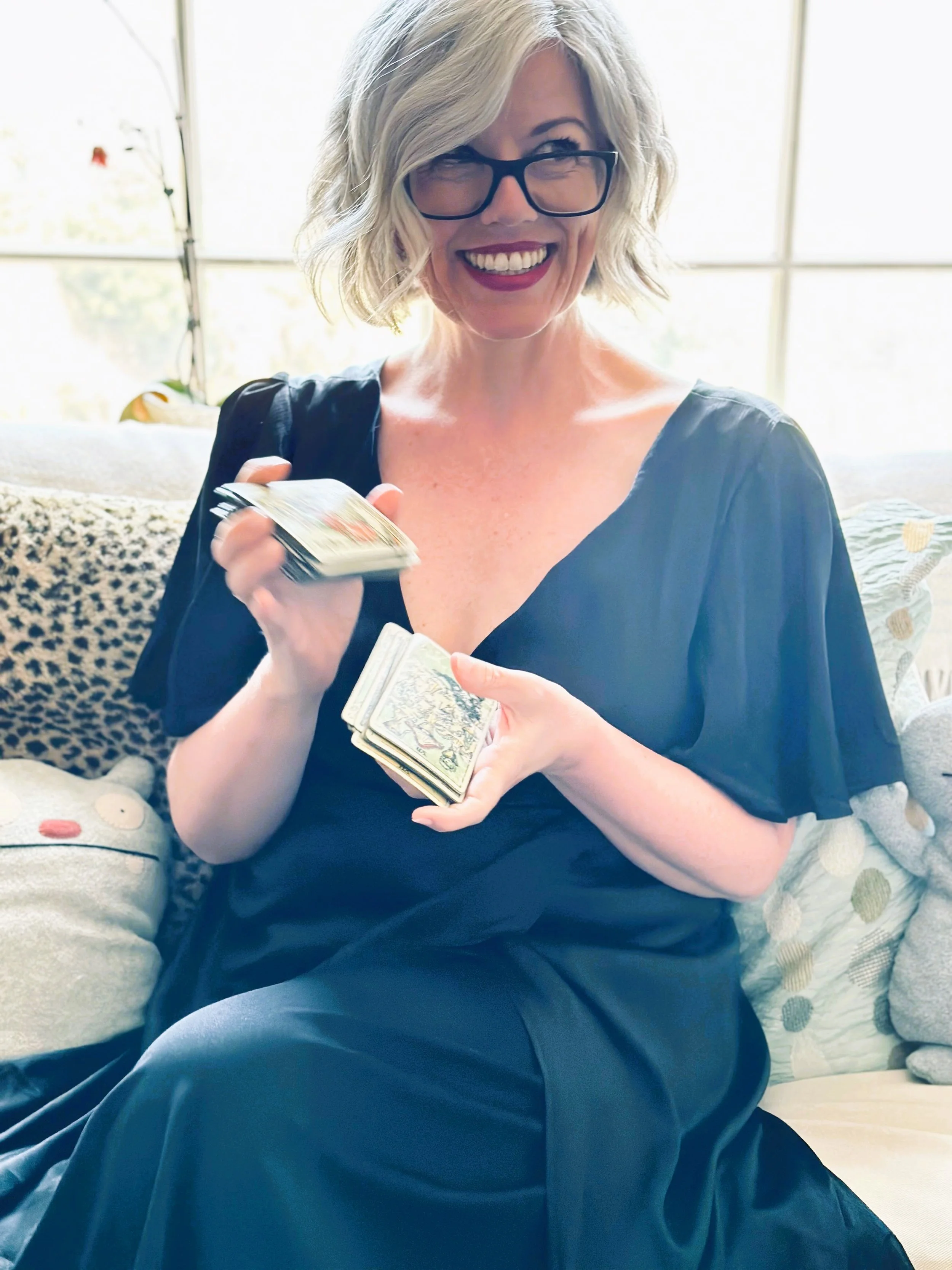 Lori Dyan holding tarot cards during a one-on-one tarot reading