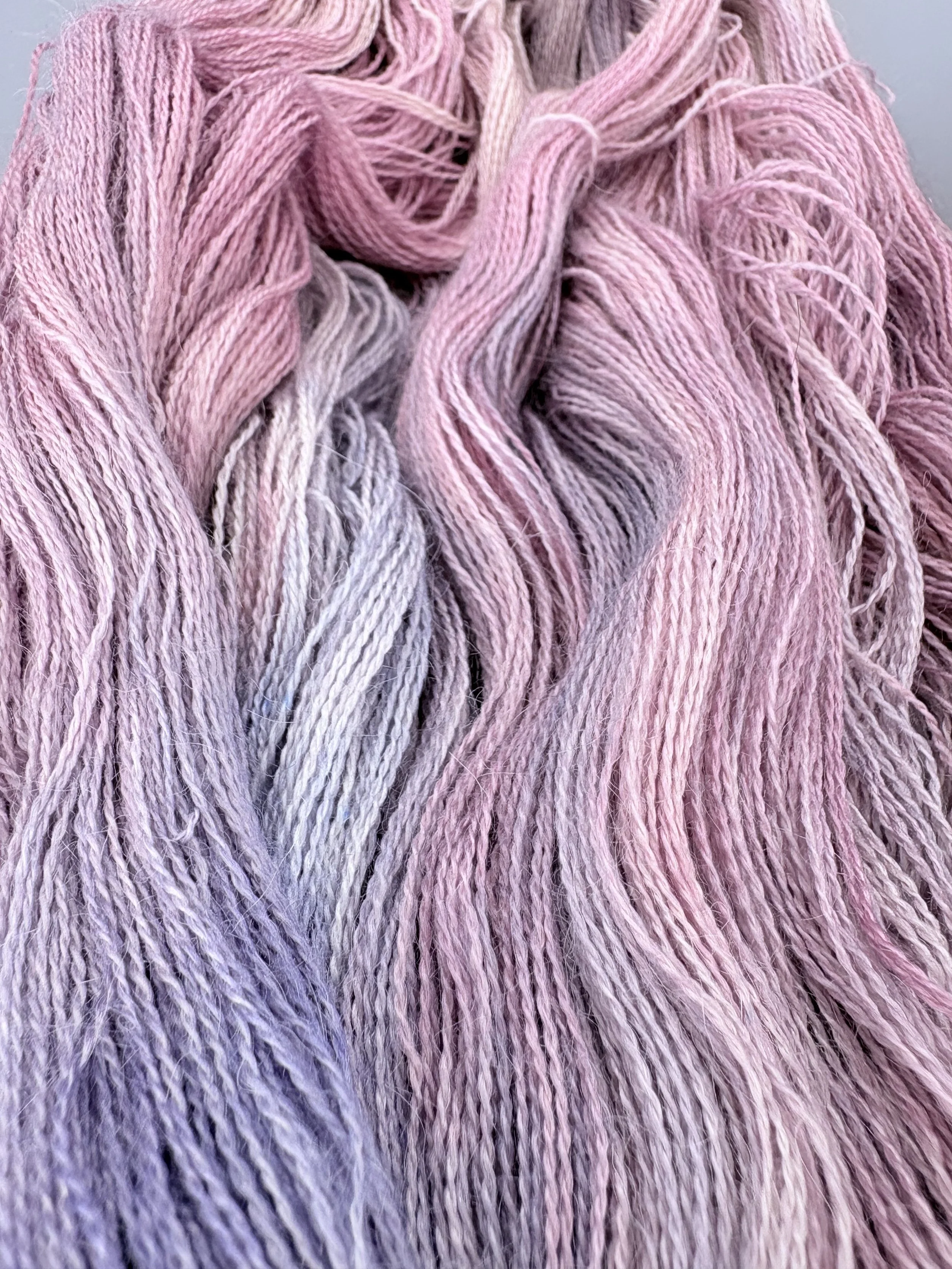 Close-up of pink and lavender colored yarn or thread.