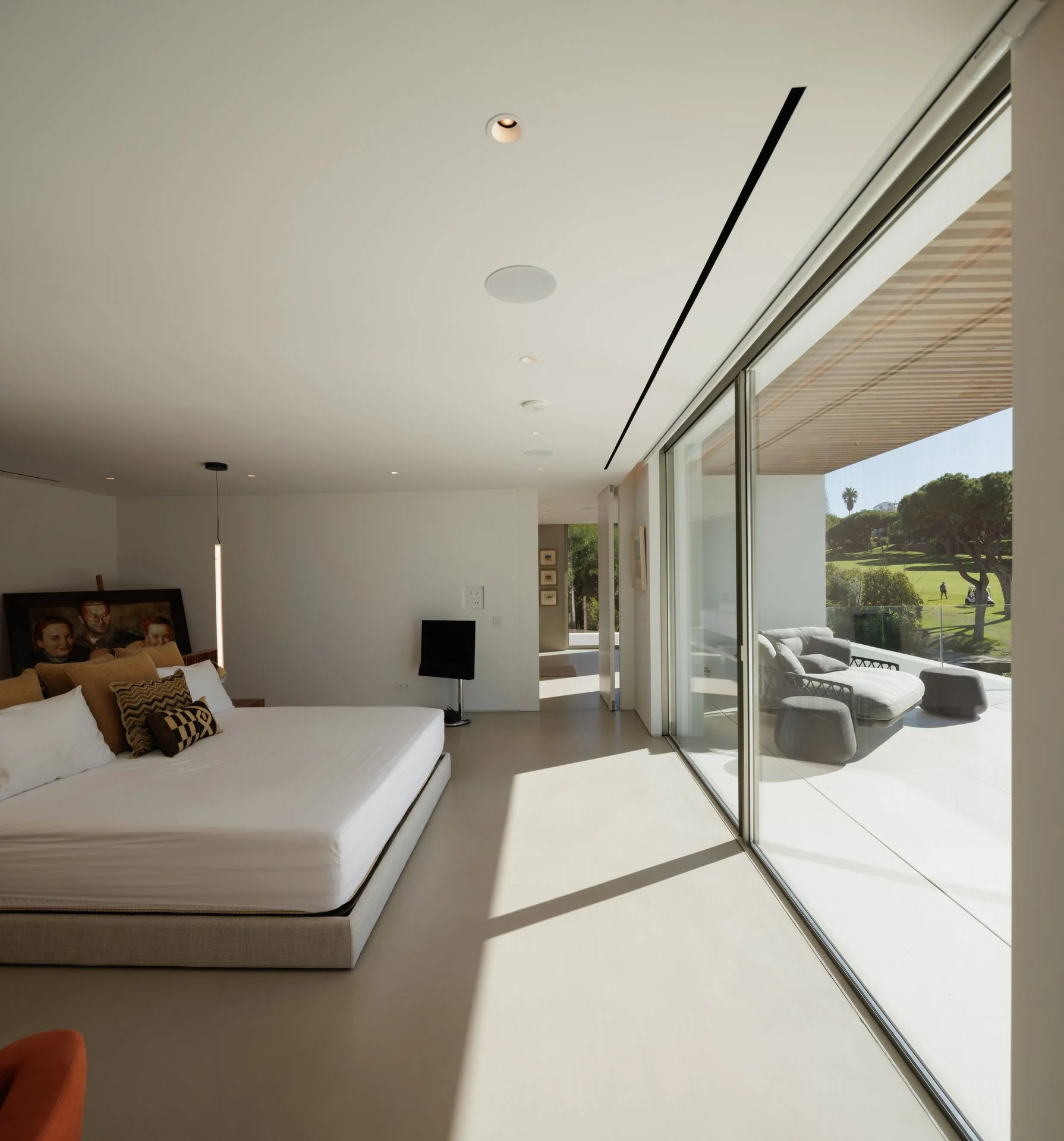 Bedroom project with floor to ceiling windows looking onto a balcony with B&B Italia Outdoor furniture 
