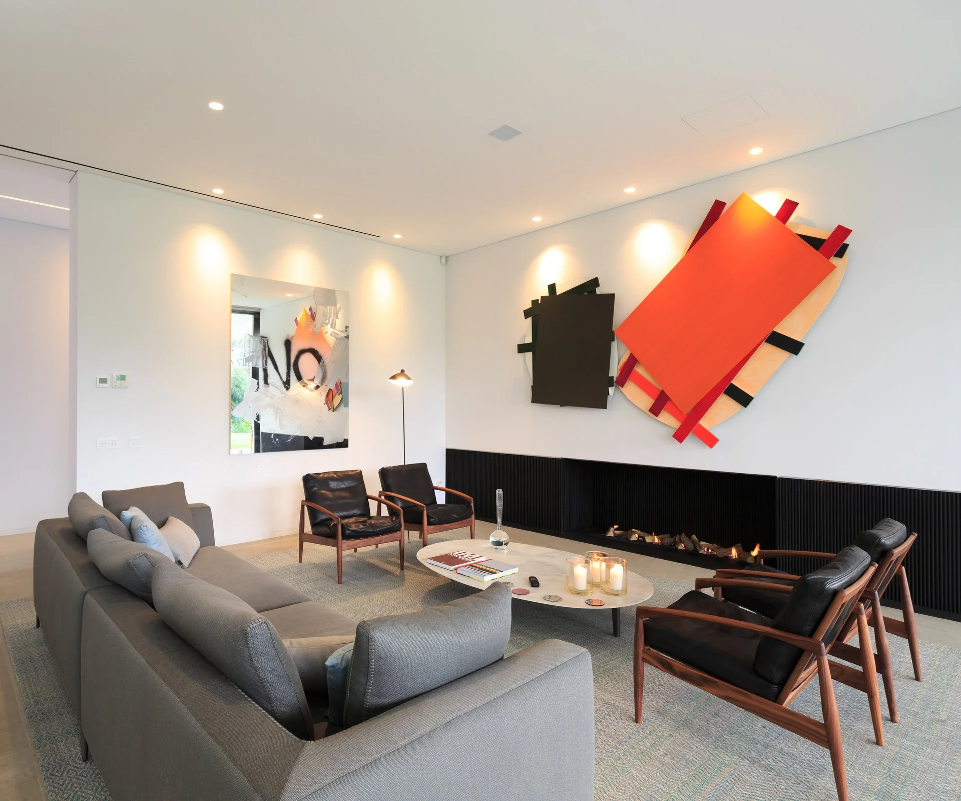 Living space with pieces from our luxury partner B&B Italia, impressive contemporary artwork and an ethanol fireplace