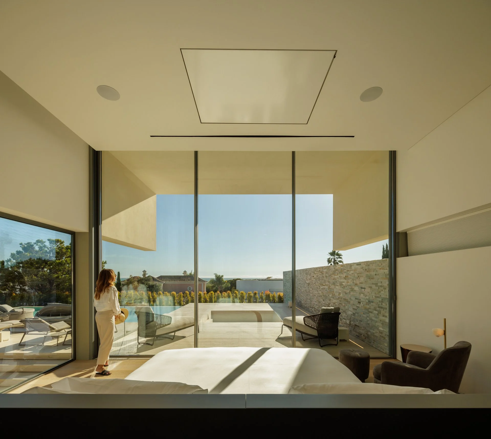 Modern bedroom project by A+ Interiors with floor to ceiling windows