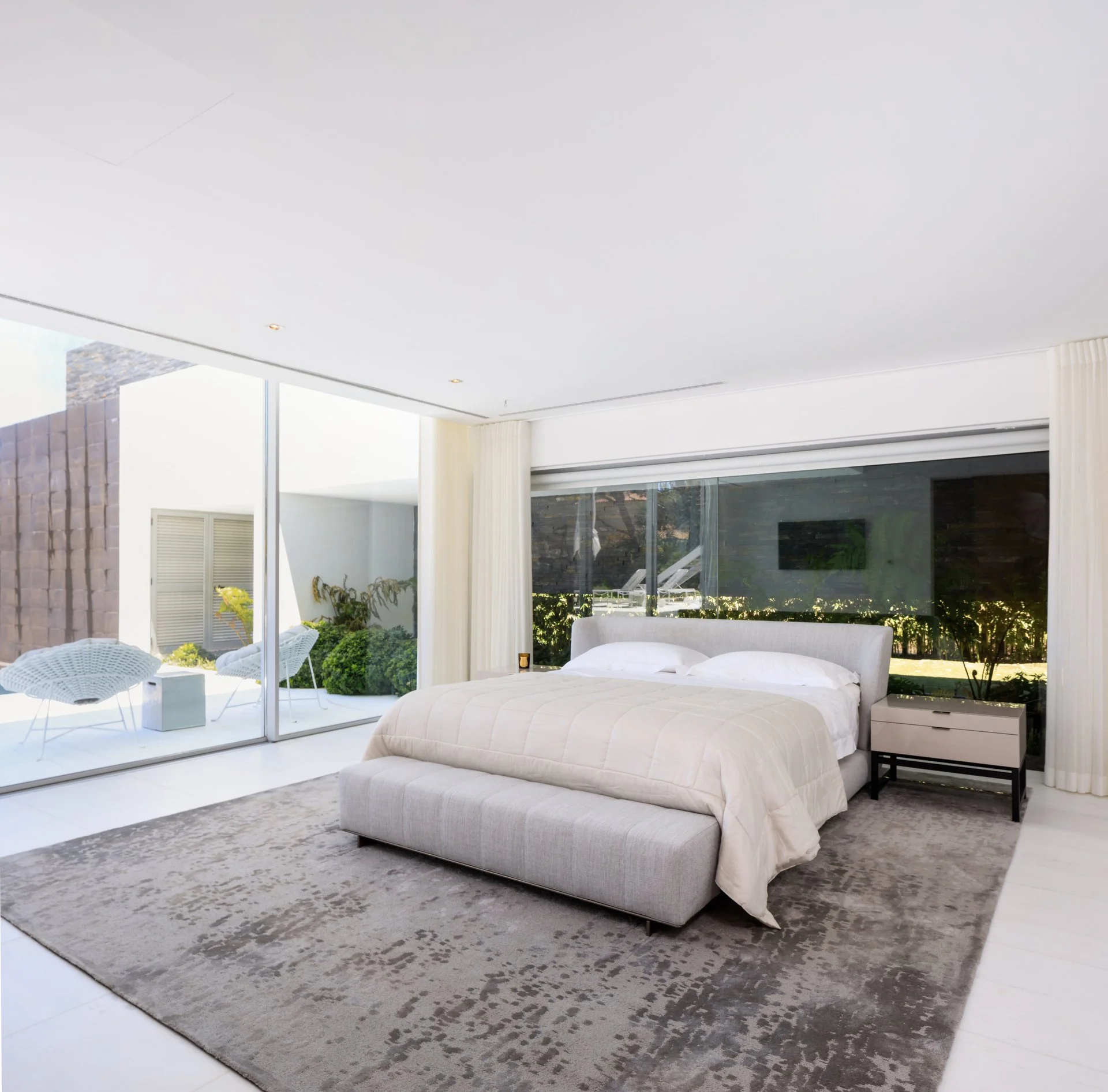 Bedroom design project by A+ Interiors, with a brightly lit room in neutral tones