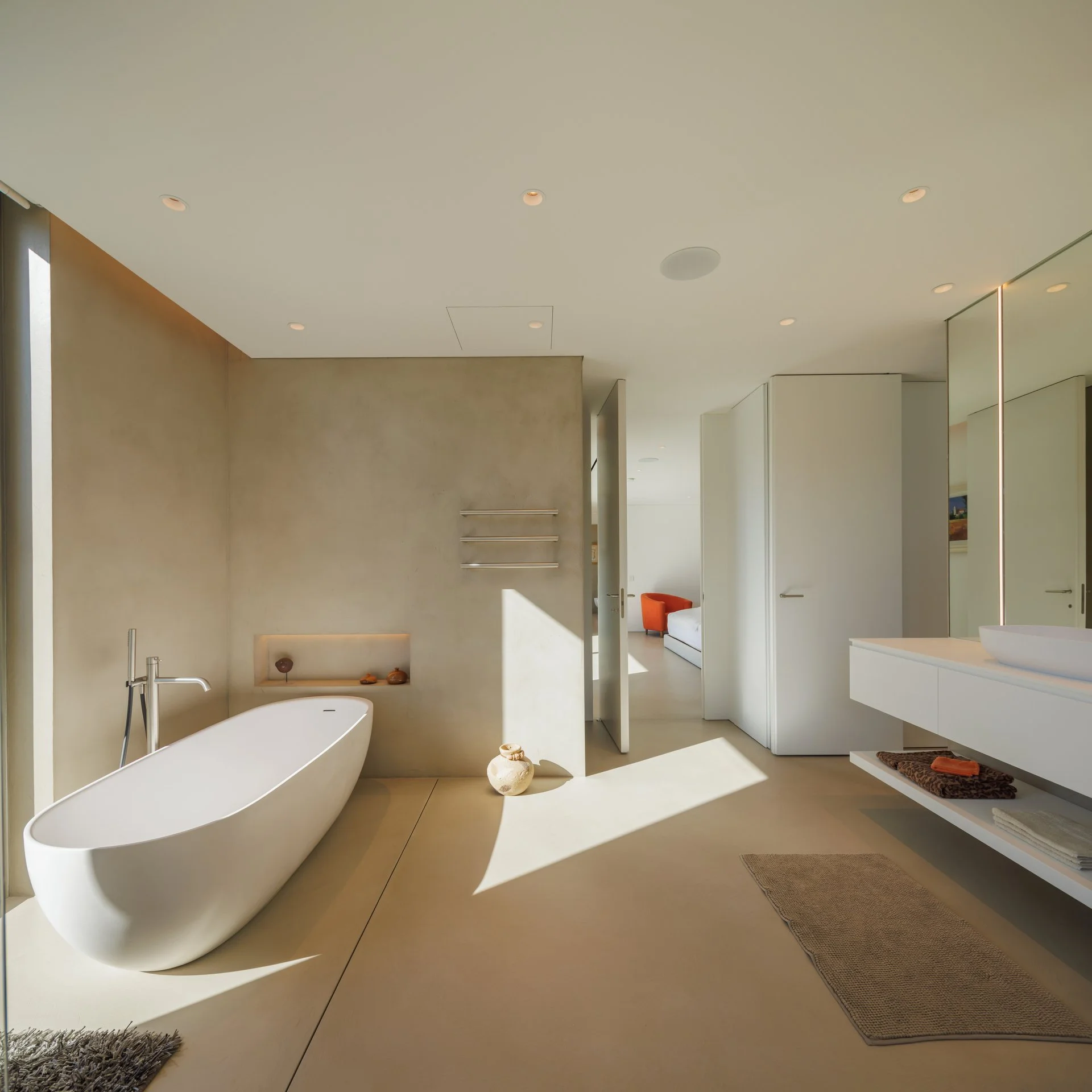 Microcement bathroom project featuring a bathtub, washbasin and tapware from our partners Gessi and Rexa