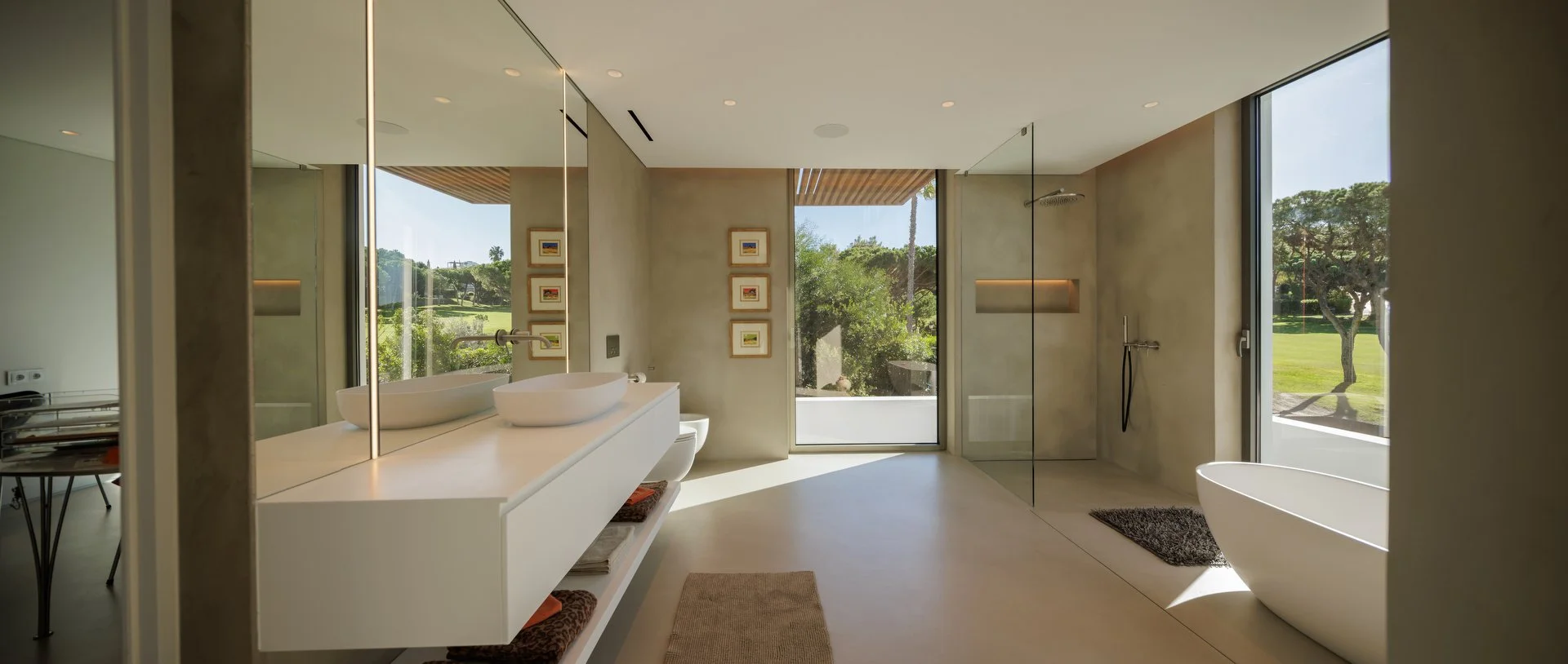 Microcement bathroom project featuring a bathtub, washbasin and tapware from our partners Gessi and Rexa