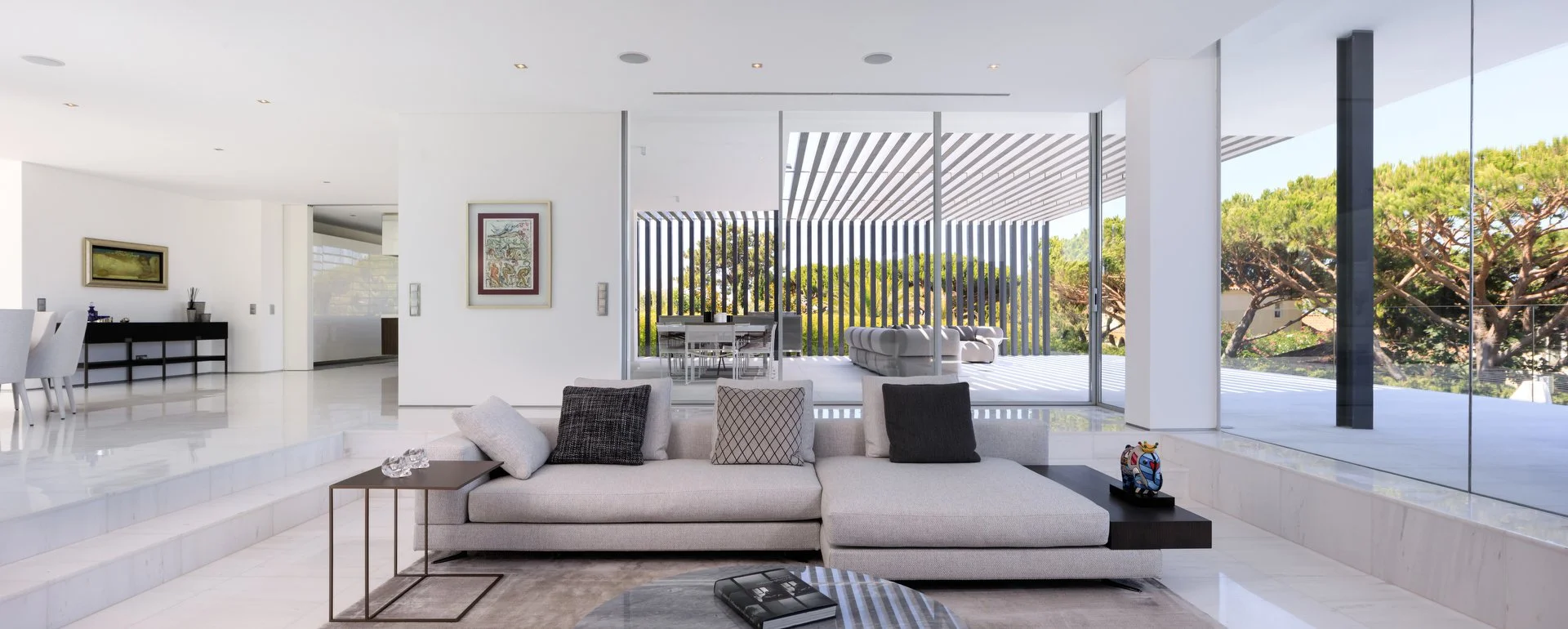 Luxury project by A+ Interiors, with an open plan living room, featuring a beige couch and black coffee table