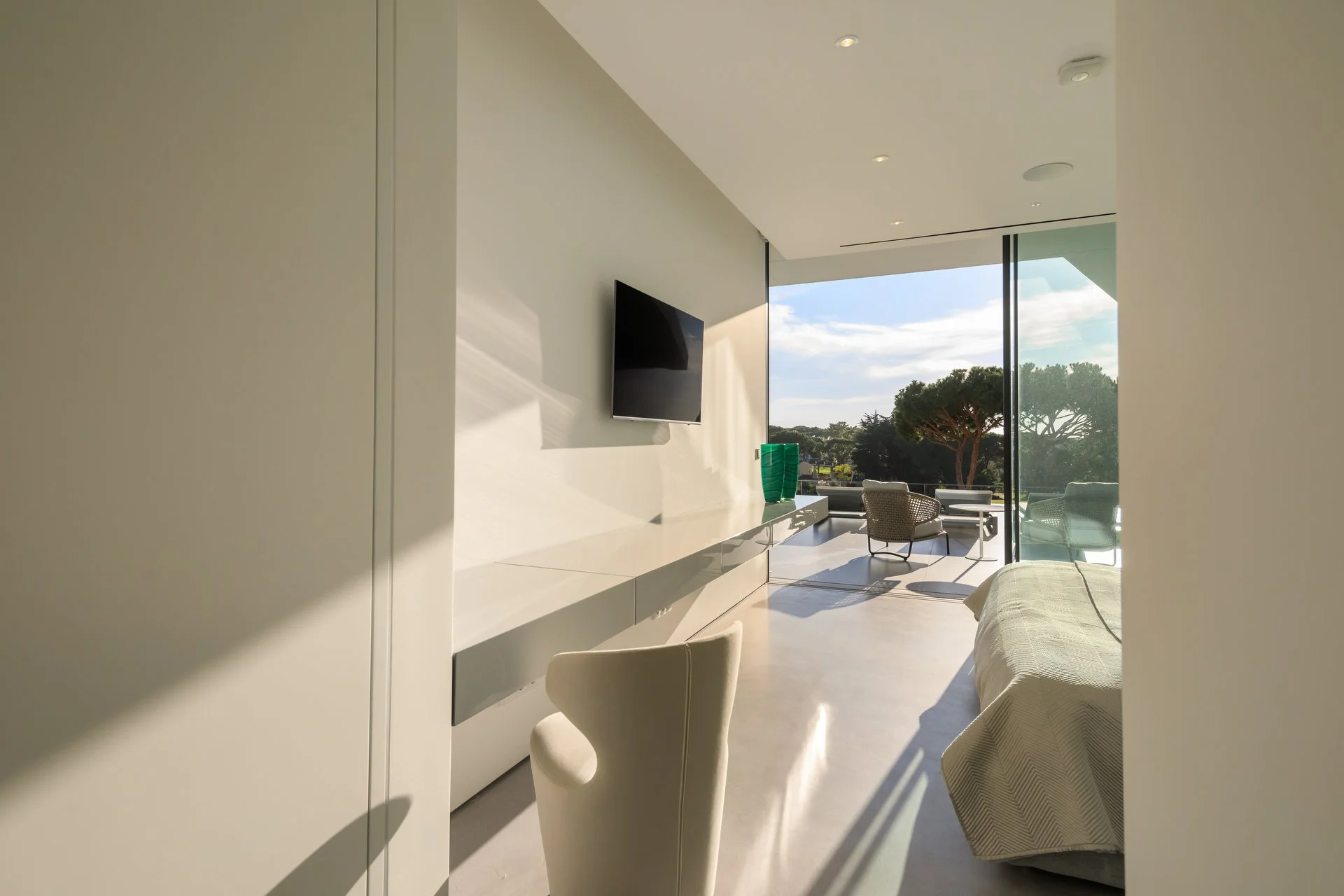 Entry way to a striking bedroom space, featuring B&B Italia furniture and breathtaking views of nature