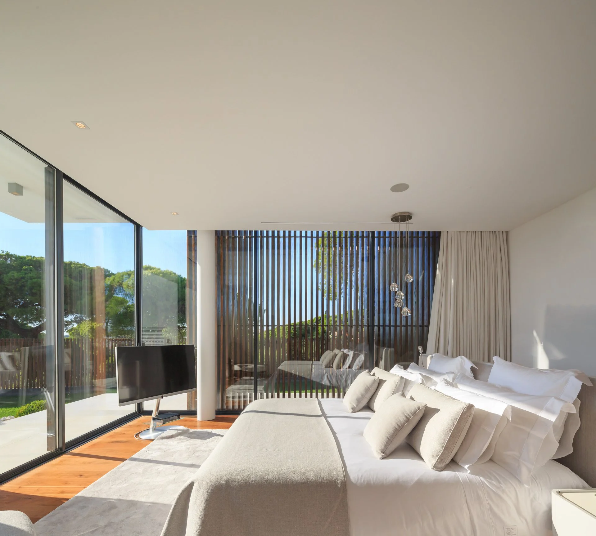 Beautifully lit bedroo in neutral tones