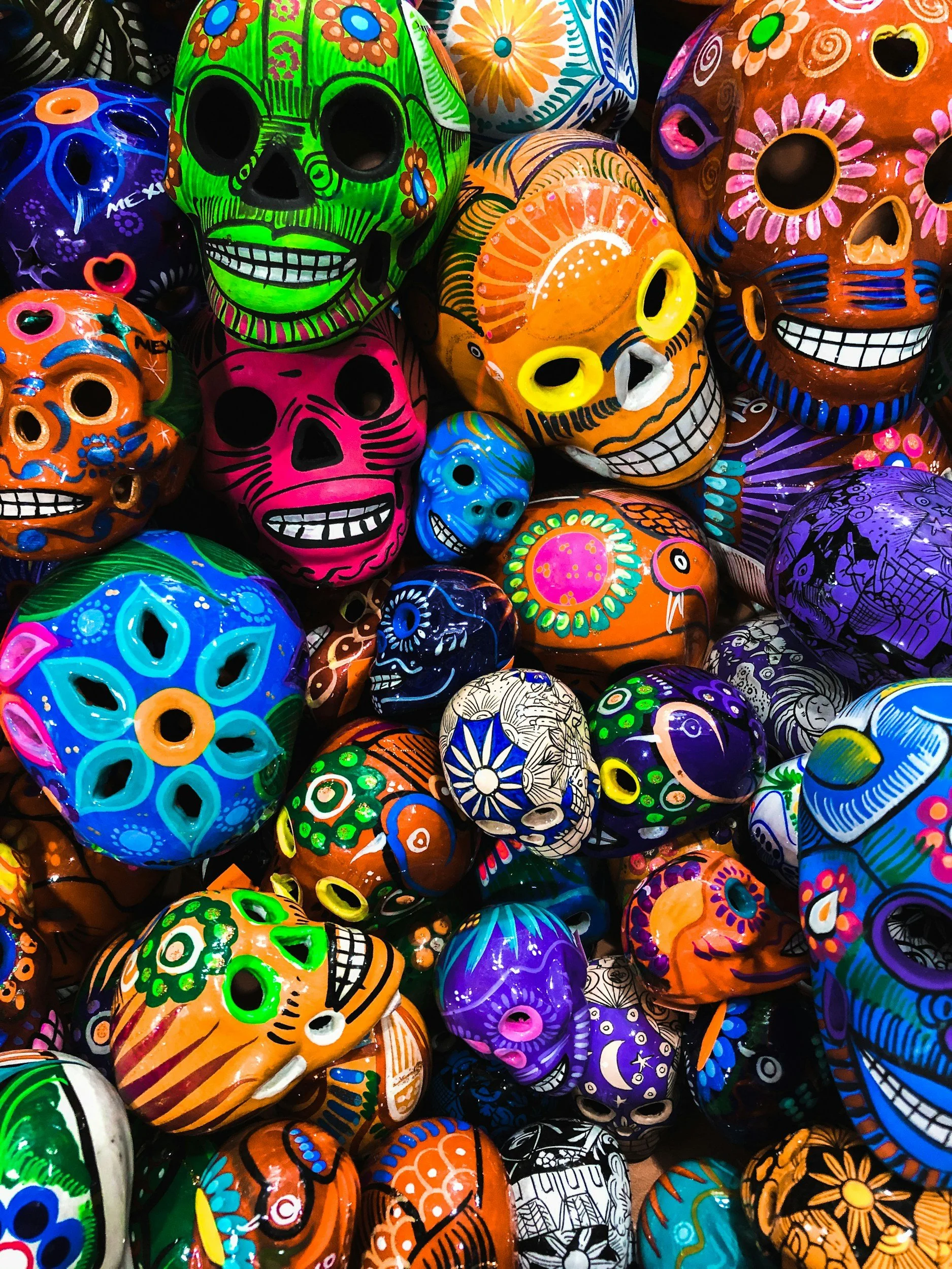 All Saints Day image of colourful skulls in green, orange, blue, pink and more