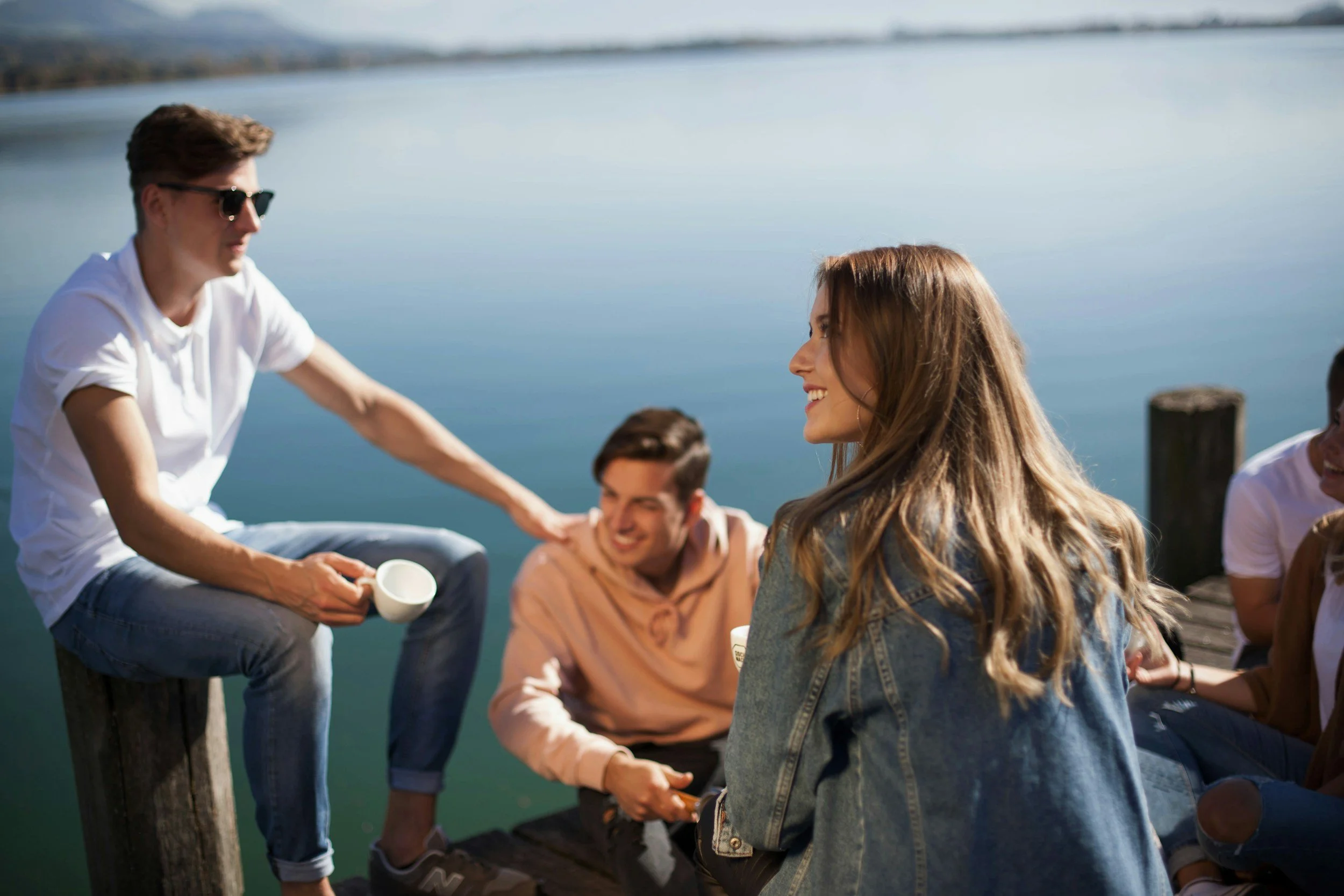 friends having coffee on a lake