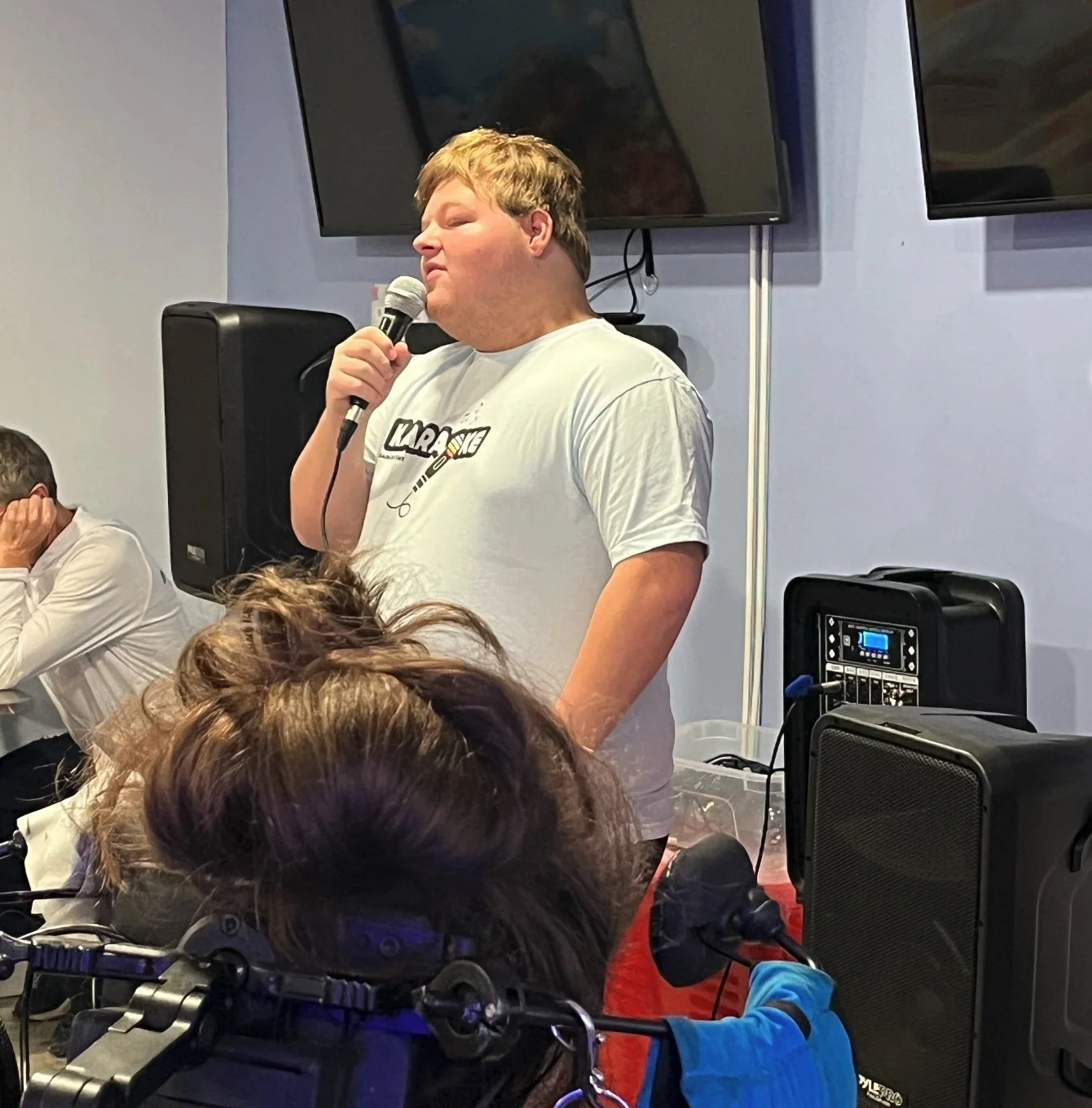 Spencer singing during a karaoke session.