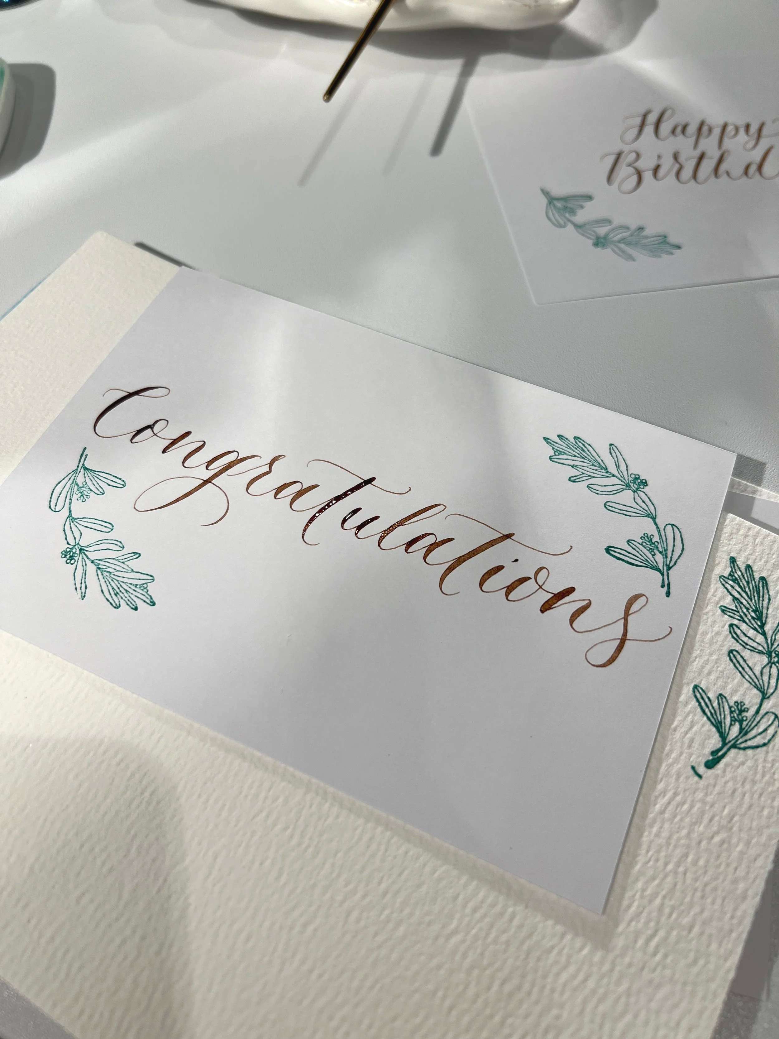 Hand written live calligraphy on notecards at a brand activation