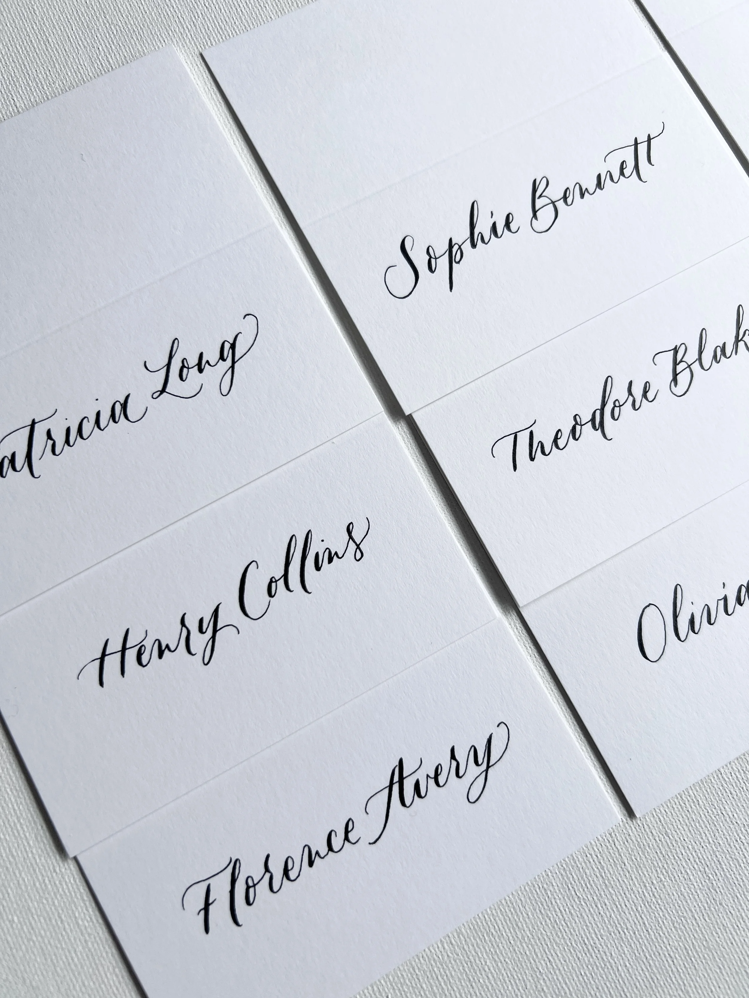 Modern Calligraphy on white place cards for an influencer dinner