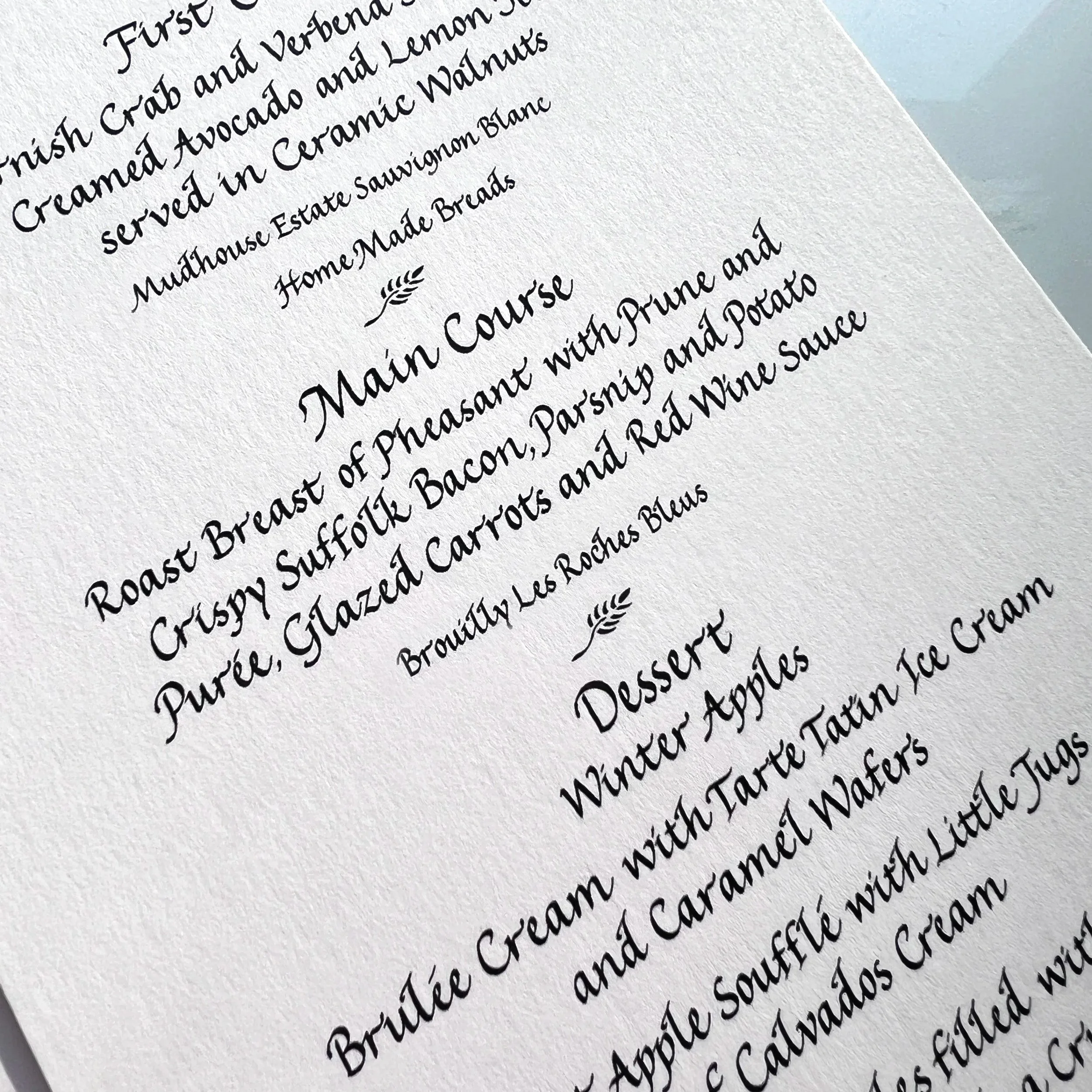 Calligraphy menu handwritten in an italic style for a luxury dining event