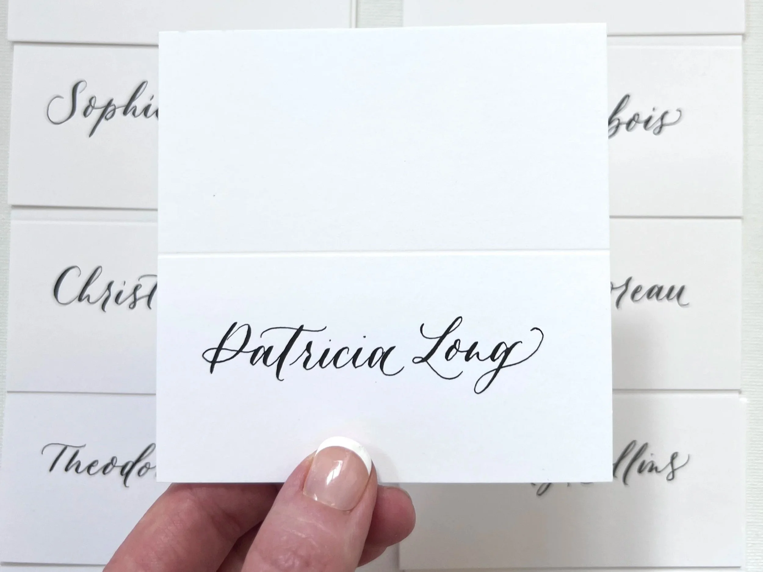 Modern calligraphy on place cards for a corporate event