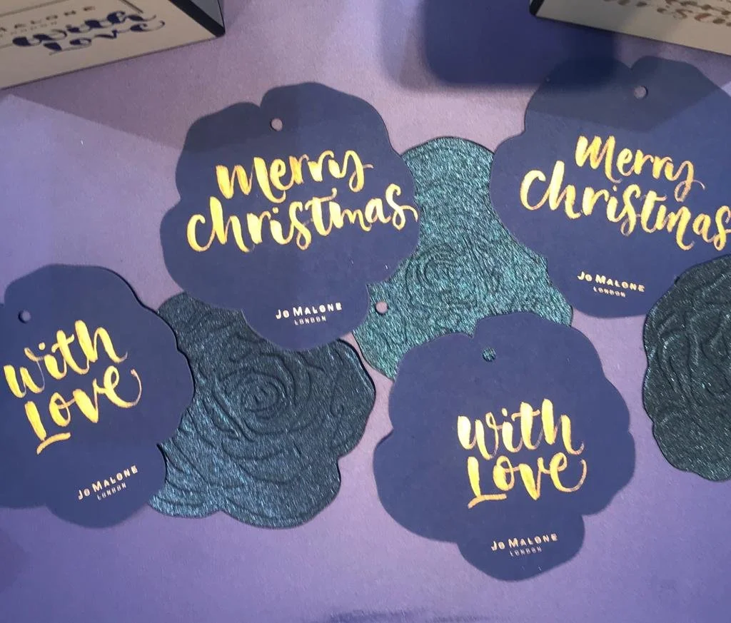 Brush lettered calligraphy on gift tags for a Christmas Jo Malone brand activation event.  