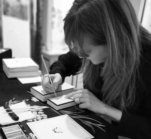 Live calligraphy in progress during a luxury retail activation