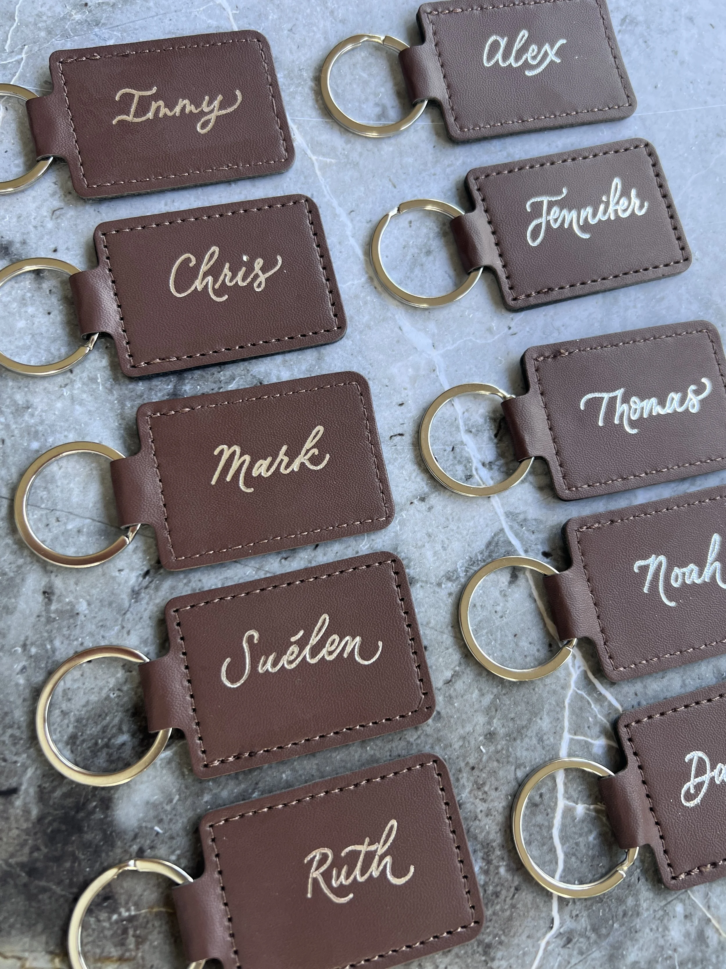 Hot foiling callirgaphy on PU leather keyrings for a brand activation event