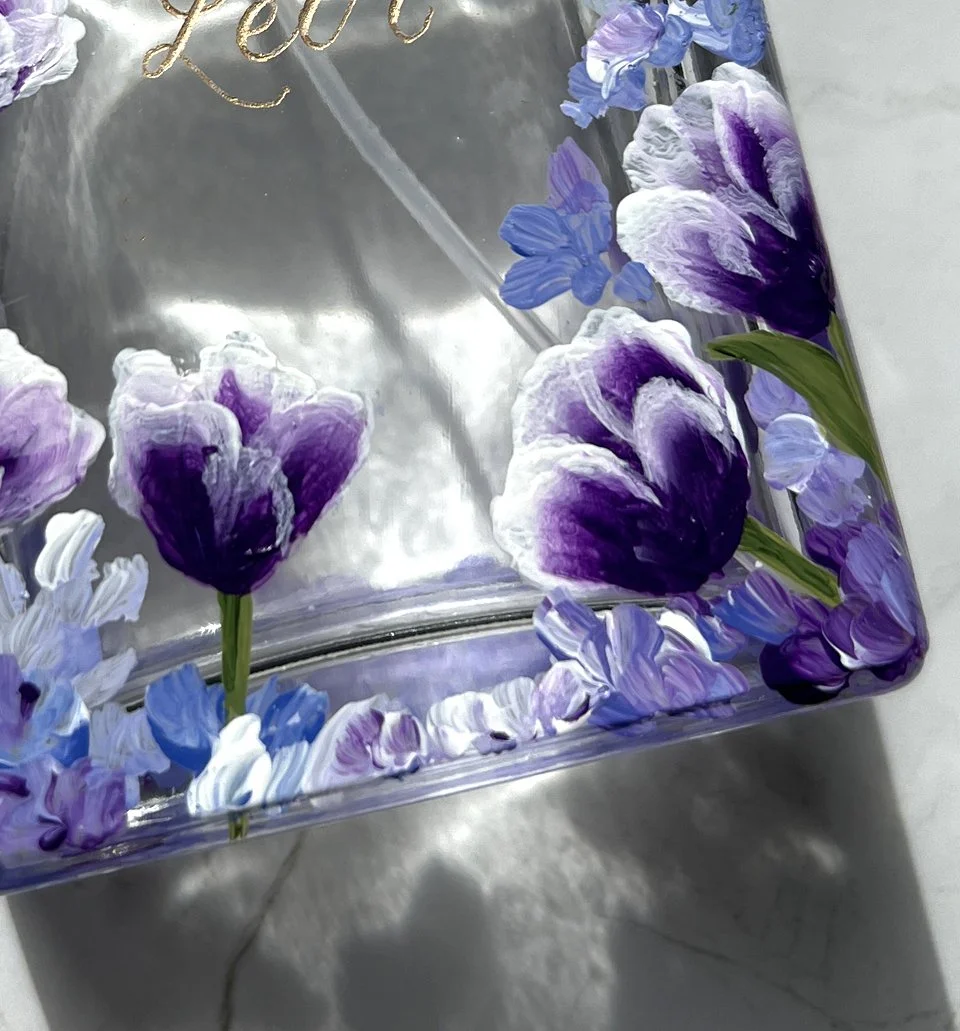 Close-up of hand-painted bottle artwork for a studio-prepared brand project