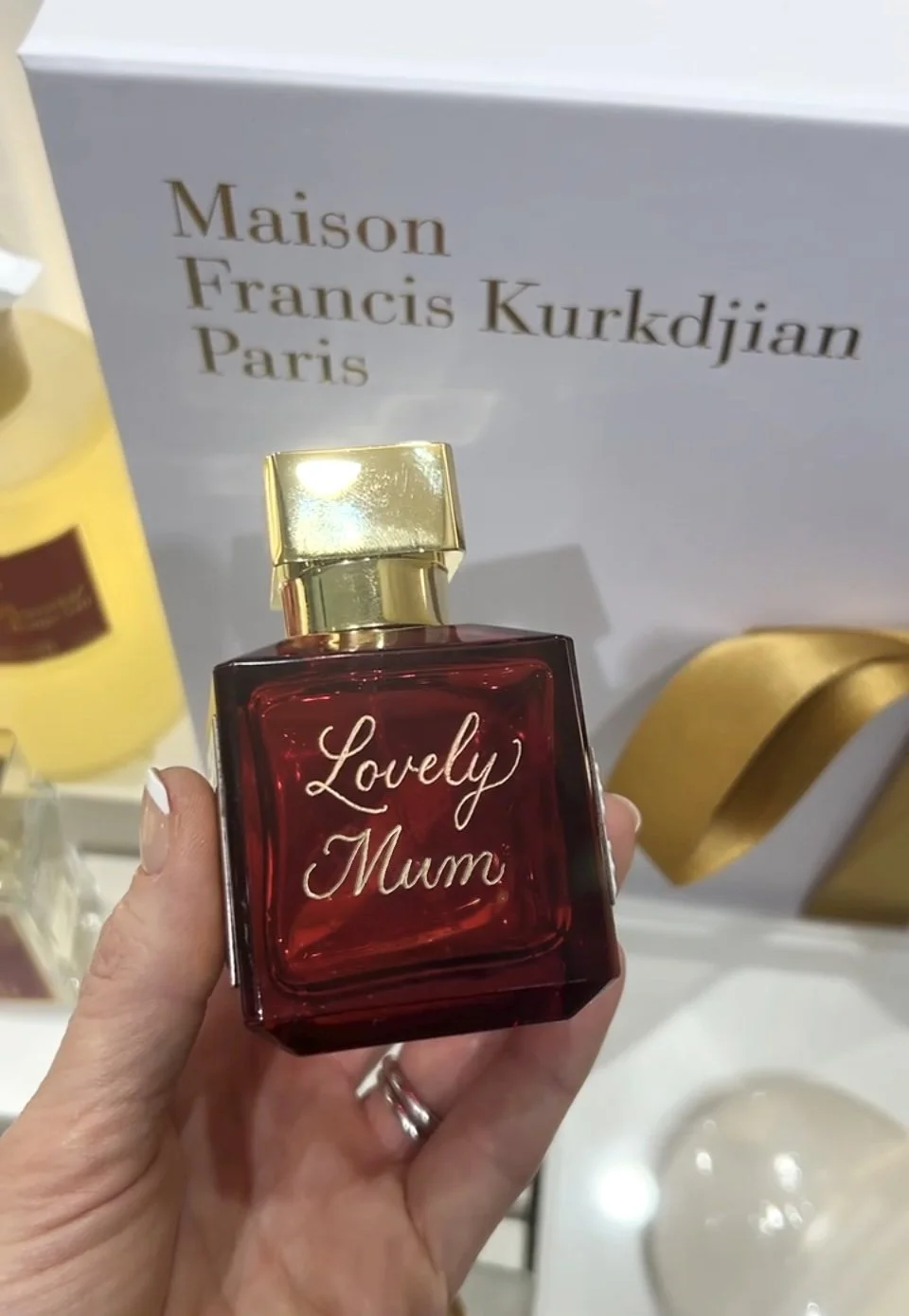 Hand engraving a name onto a MFK perfume bottle at a live brand activation