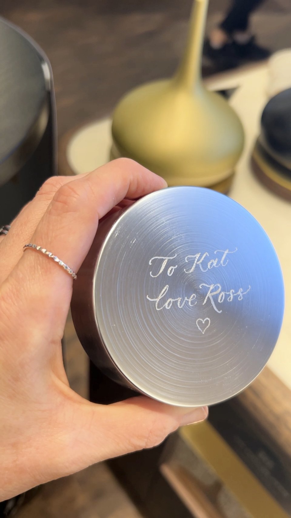 Hand engraved Rituals candle lid at a brand activation event