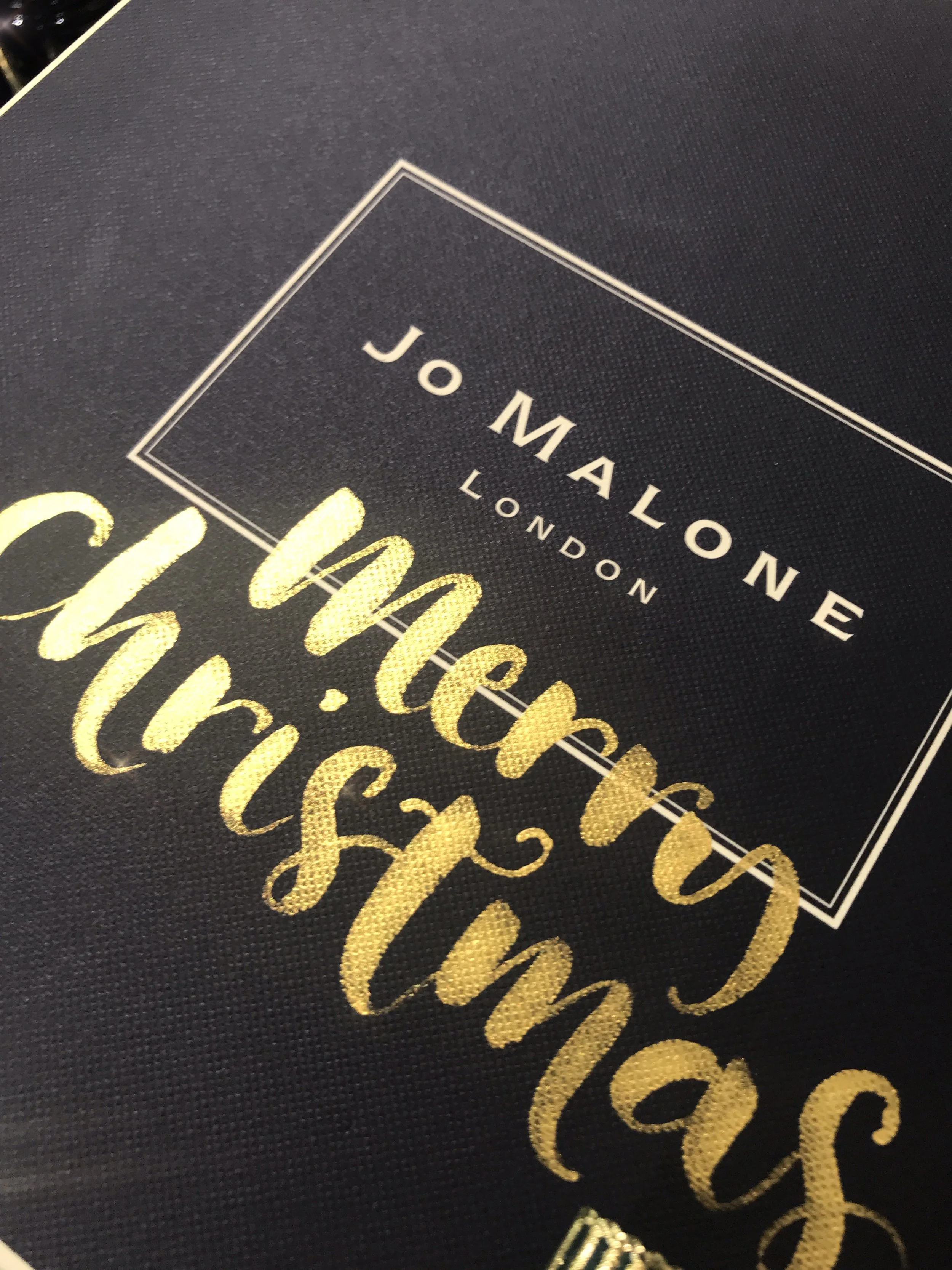 Live gold calligraphy on Jo Malone London gift box at a Christmas brand activation