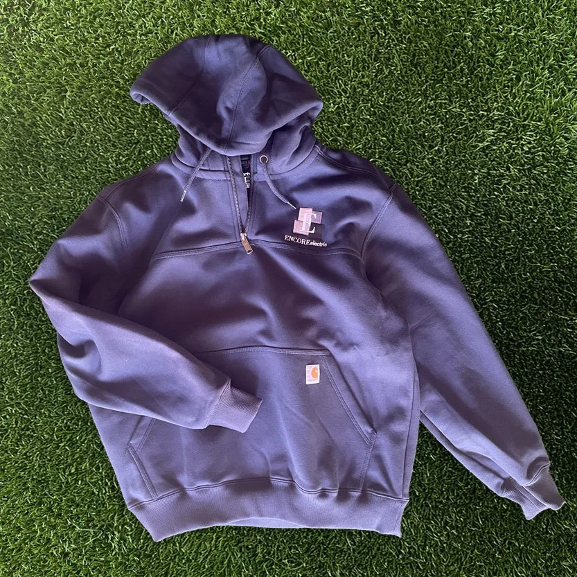  we can apply your brand in embroidery or screen print or patch or anything you can imagine to fully custom retail items like this Carhartt quarter zip for Encore Electric.