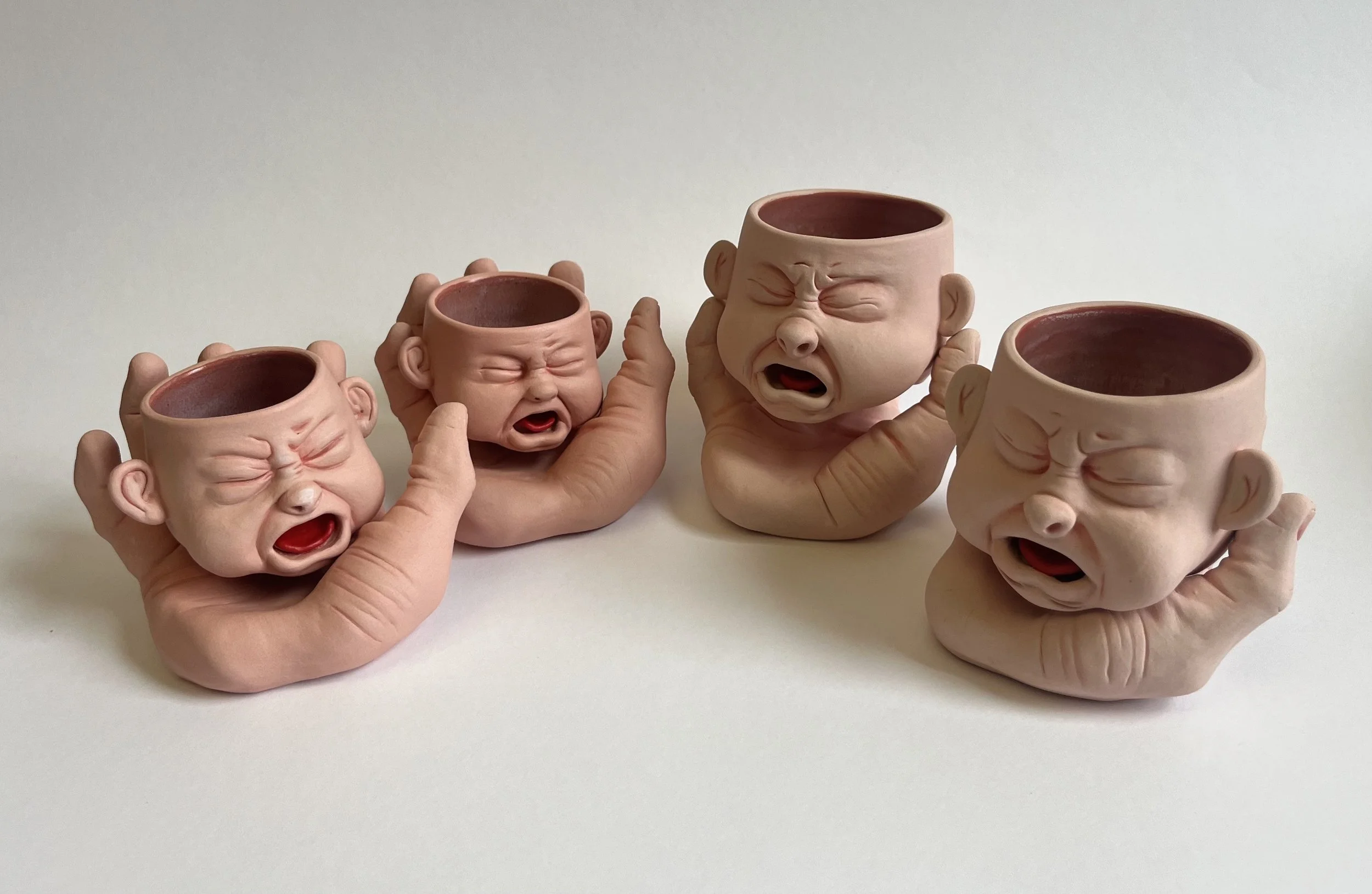 BabyFace Mugs: Cup + Saucer 
Stoneware, cone 6 firing, underglaze and glaze 
Hand-sculpted ceramic cups w/ hand sculpted hands (saucers)