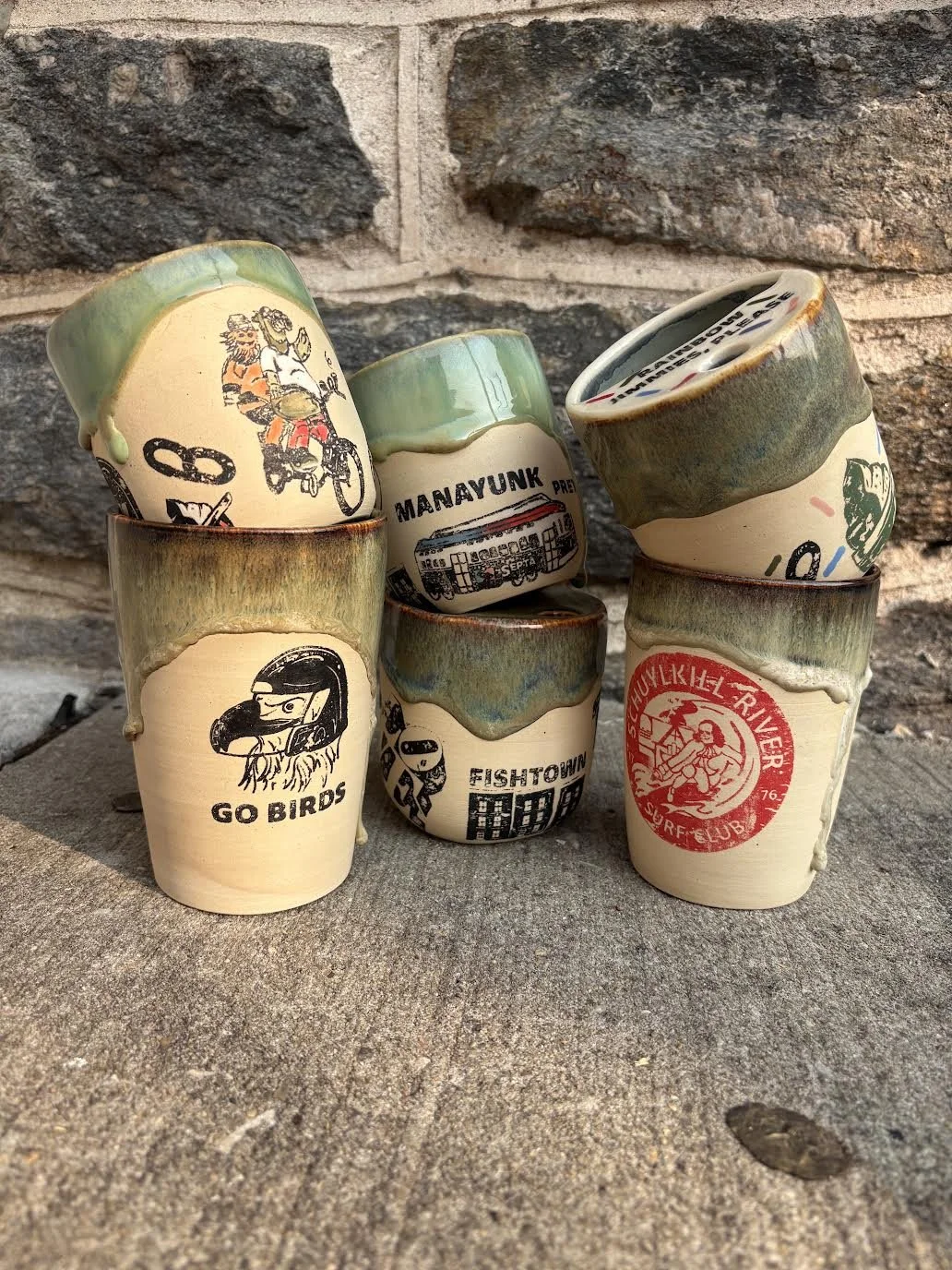 BabyFace Studio:
Hand thrown Philly Travel Tumblers w/ lids- stoneware, cone 6, underglaze, glaze, original custom screen printed decals 