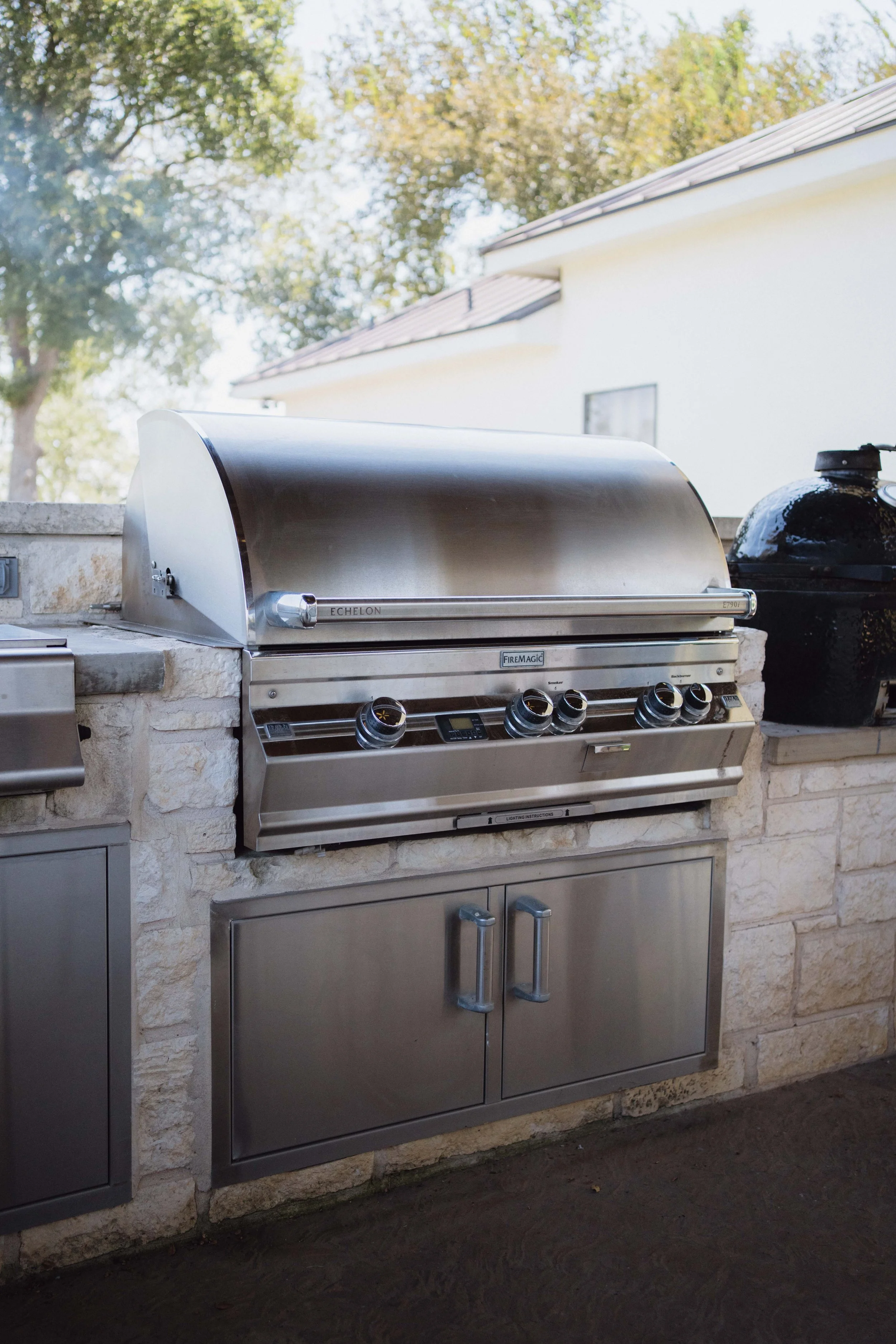 Covered patio outdoor kitchen with limestone counter by Cozy Fireplace + Patio in San Antonio