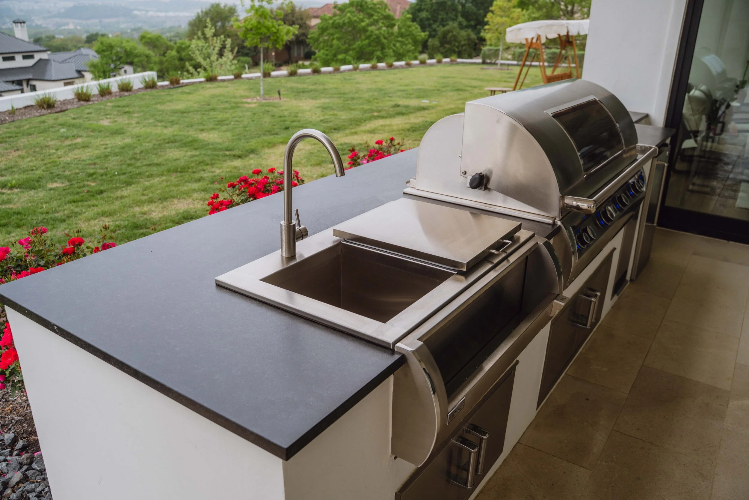 Outdoor kitchen beverage station and built-in sink detail in San Antonio backyard by Cozy Fireplace and Patio