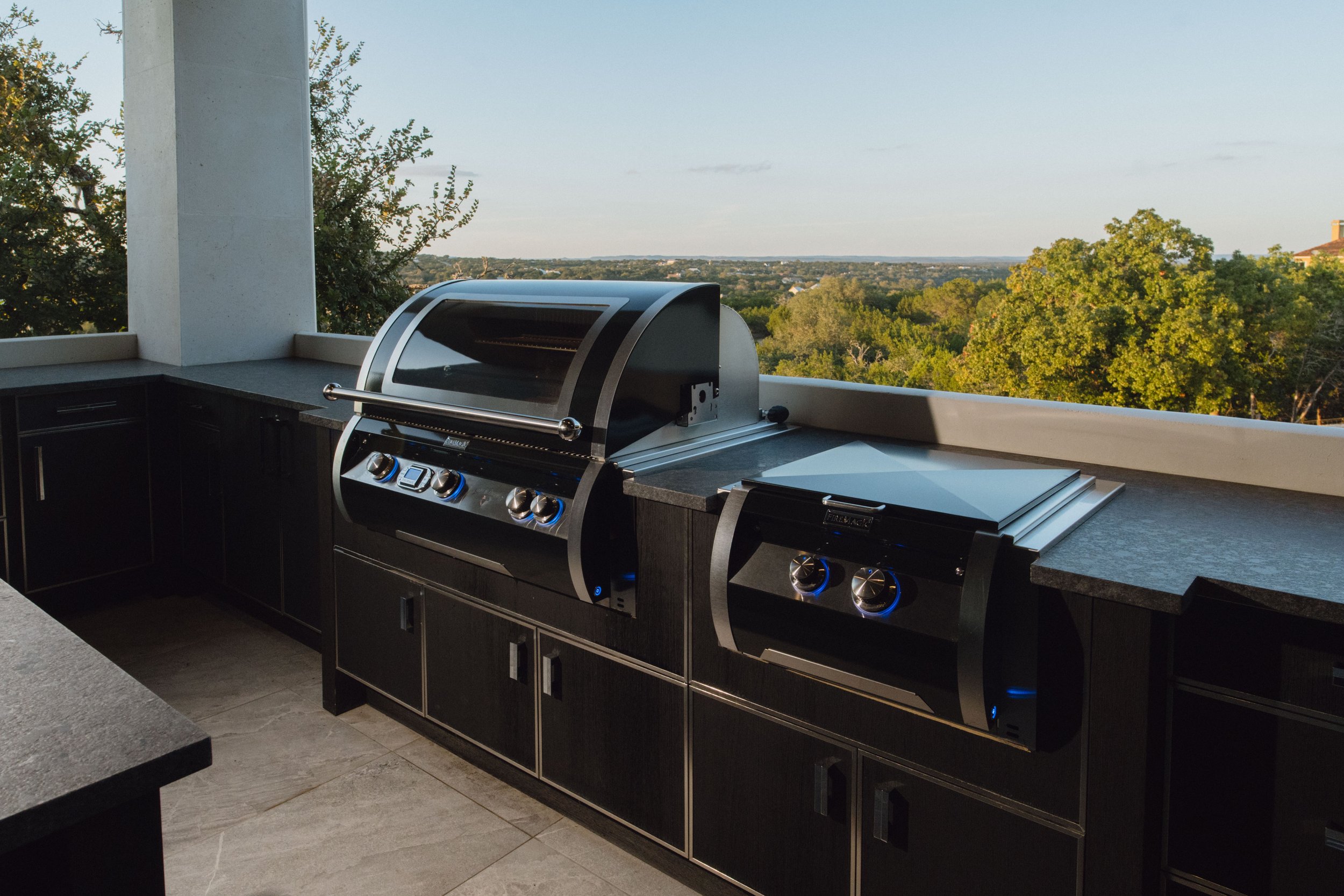 Built-in BBQ grill by Cozy Fireplace + Patio in San Antonio backyard