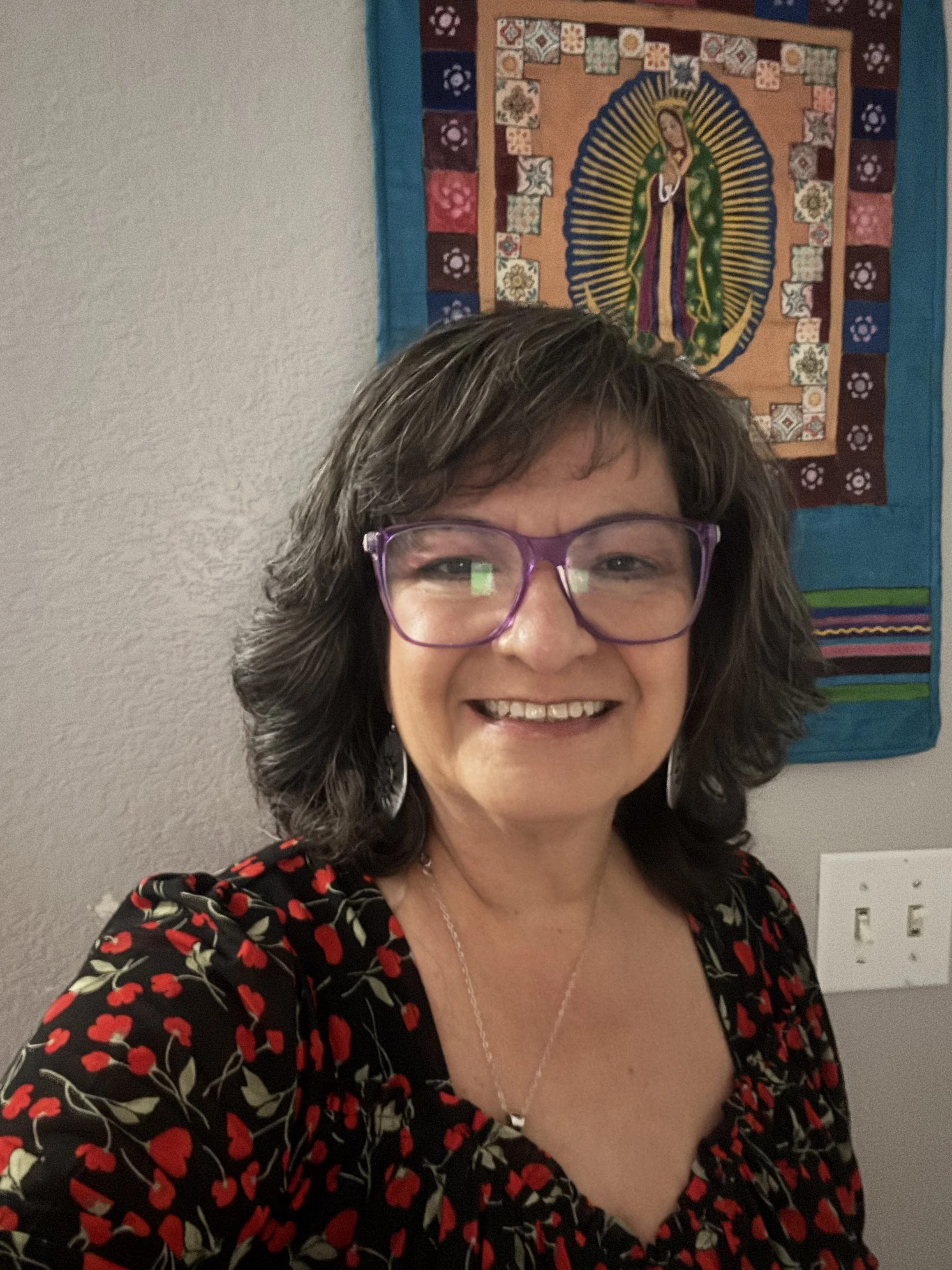 Denise Torrez Smiling wearing a flower shirt.