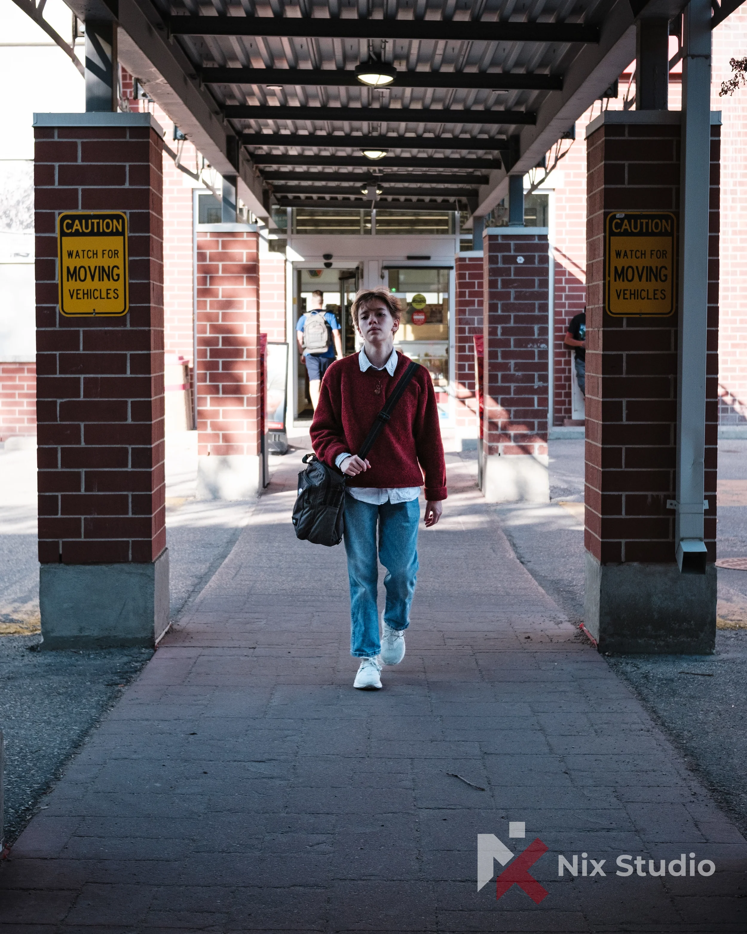 Portrait of man in Winnipeg walking by columns 