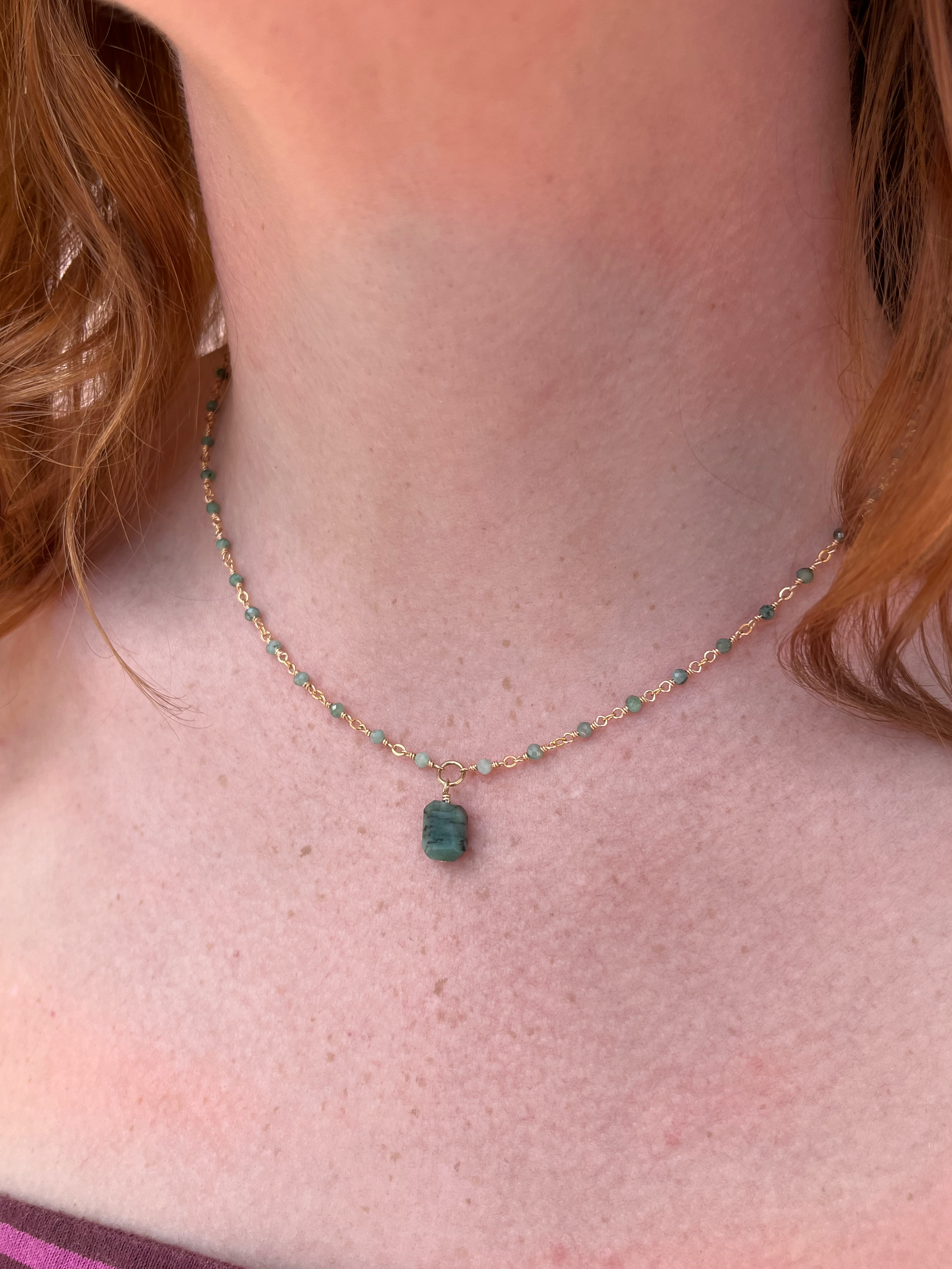 Emerald with stone charm