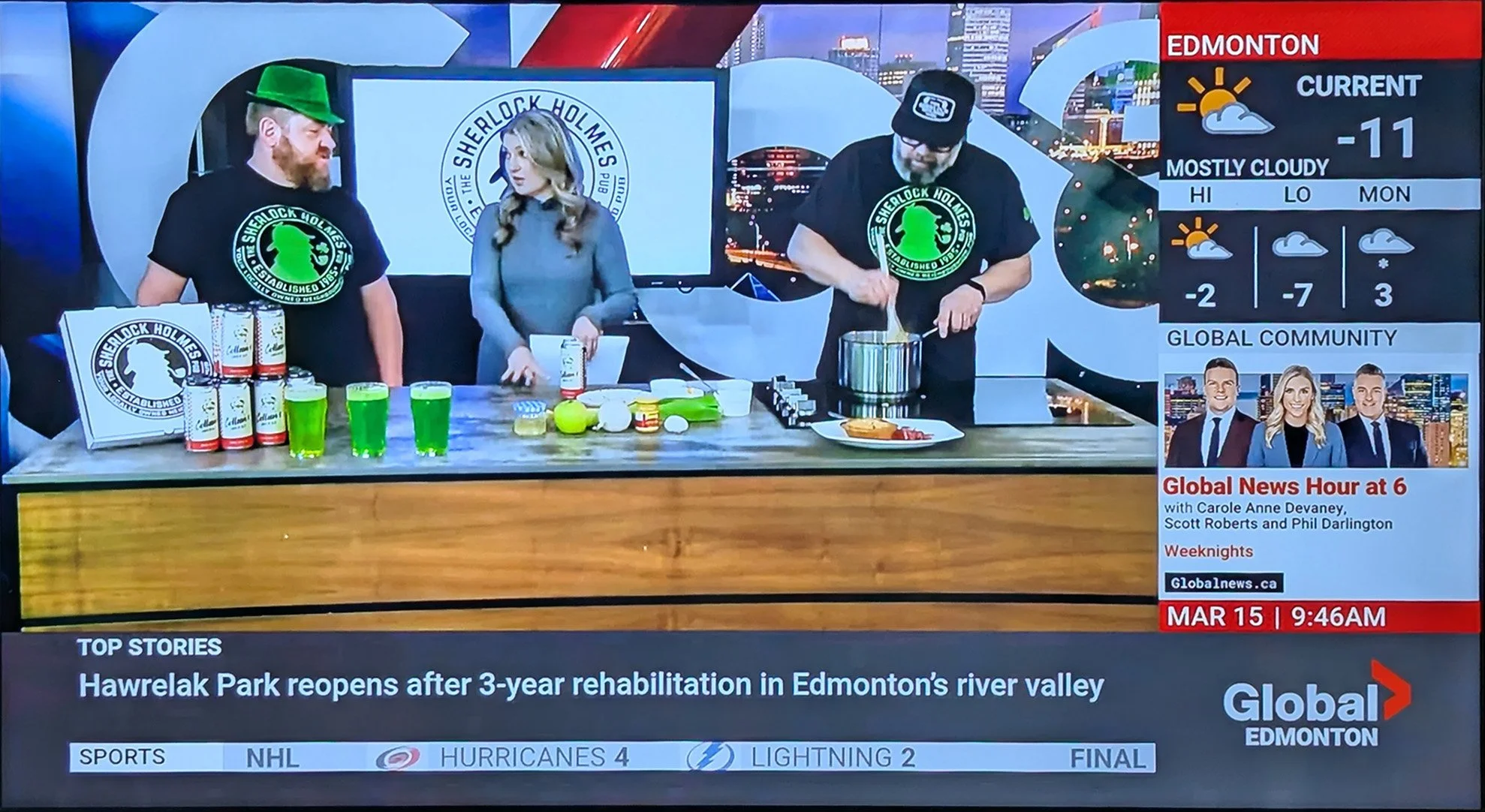 Television news segment with two men and a woman at a table, advertising Sherlock Holmes-themed merchandise. Jordan and Eric from Sherlock's on Global tv for a cooking with beer segment. Pork, Apple & Ale Pie cooking segment using Colleen's Amber Ale