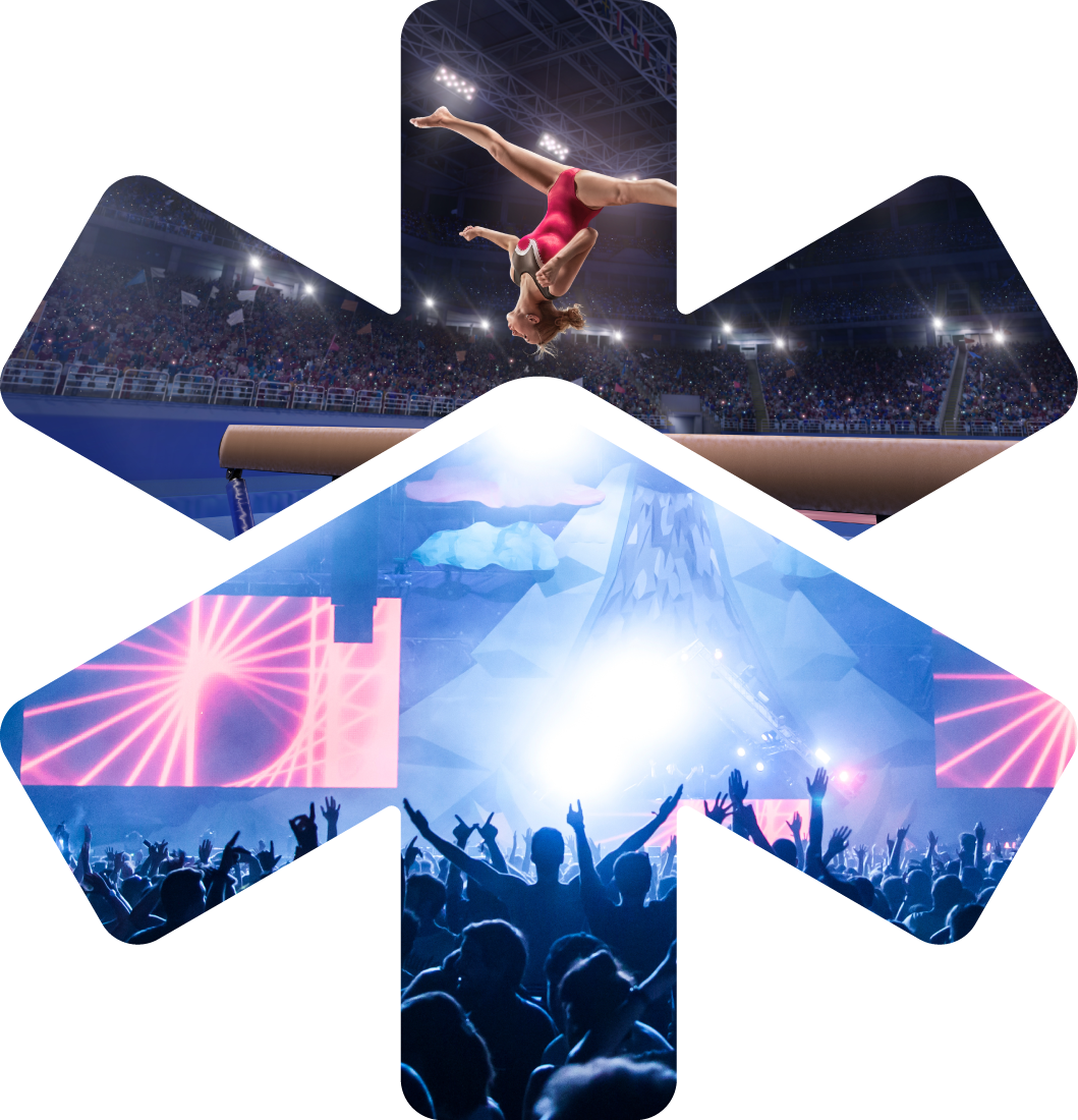A gymnast performing a backflip on the balance beam in a sports arena with an audience and a concert stage with bright lights and screens in the background.