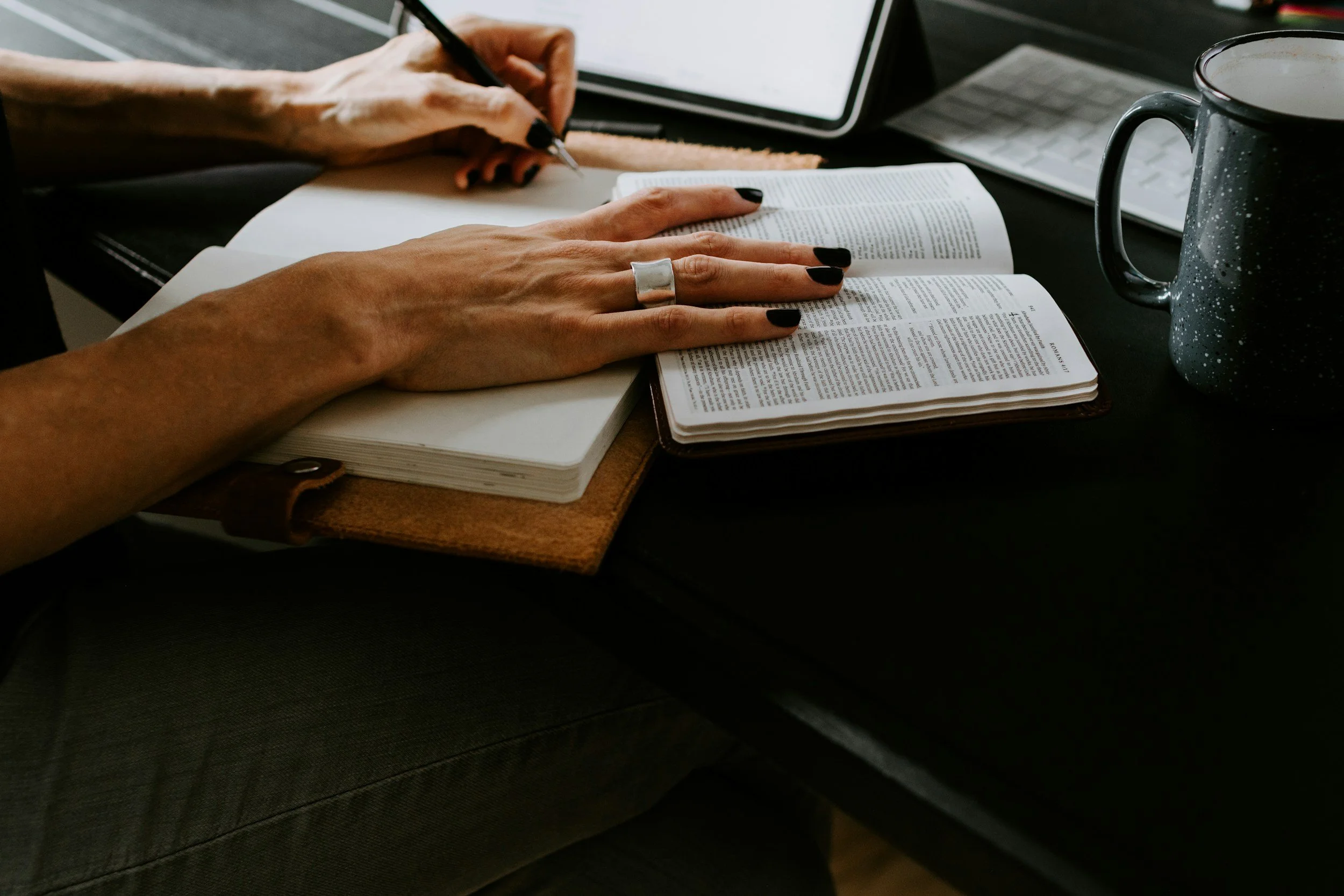 Mom with notebook and open bible.