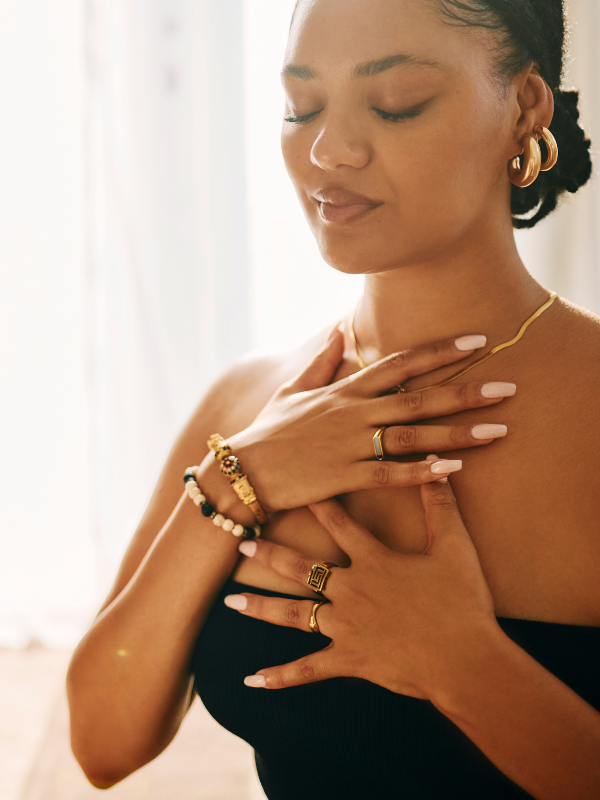 Woman with hands on chest taking a deep breath.