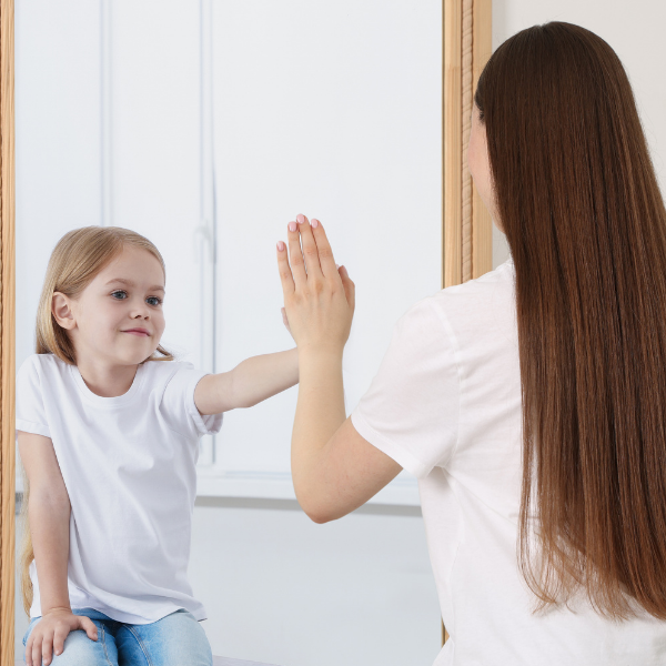 Mother looking in the mirror and seeing a child's reflection