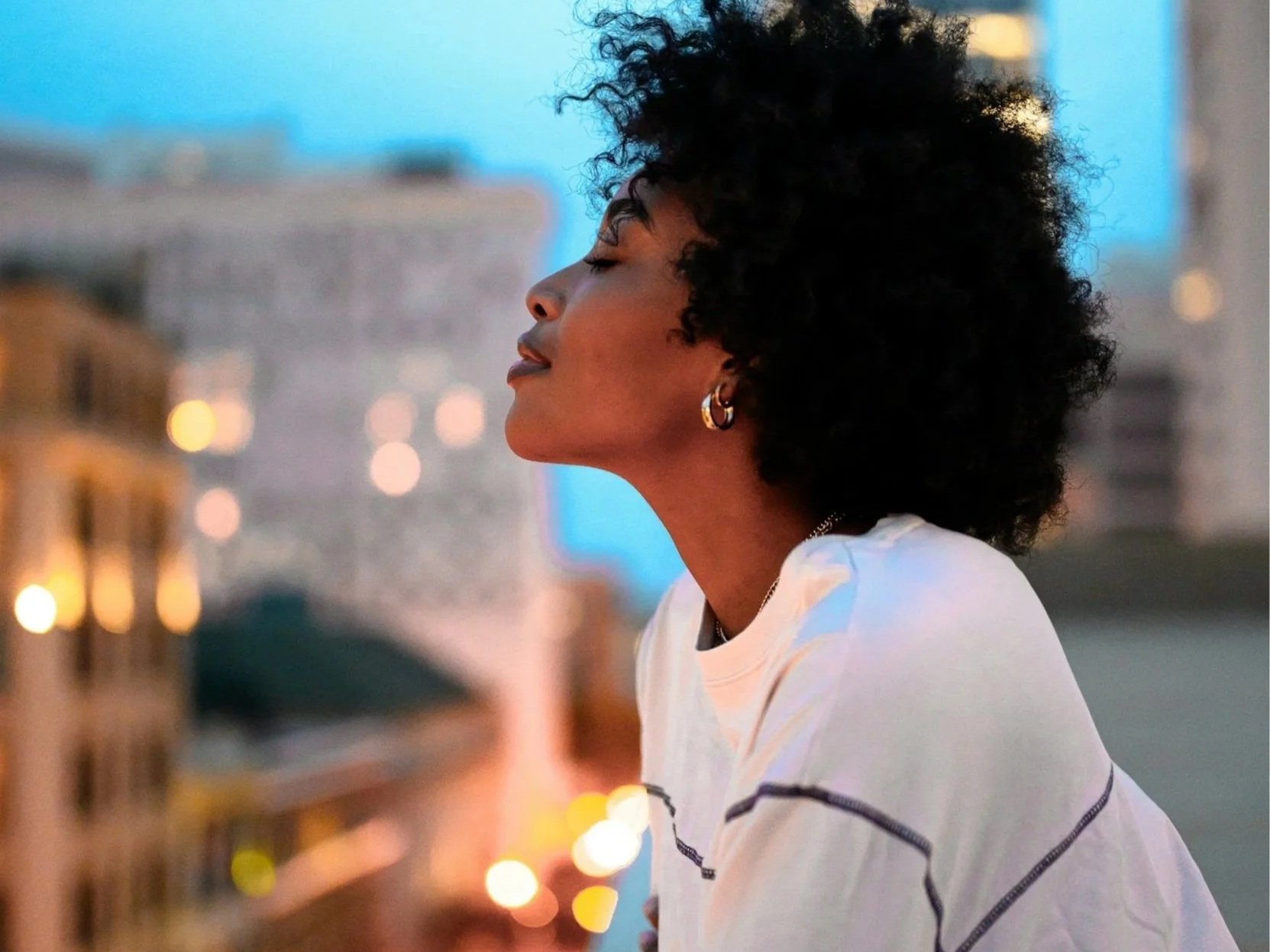 African American mom standing outside in peace.