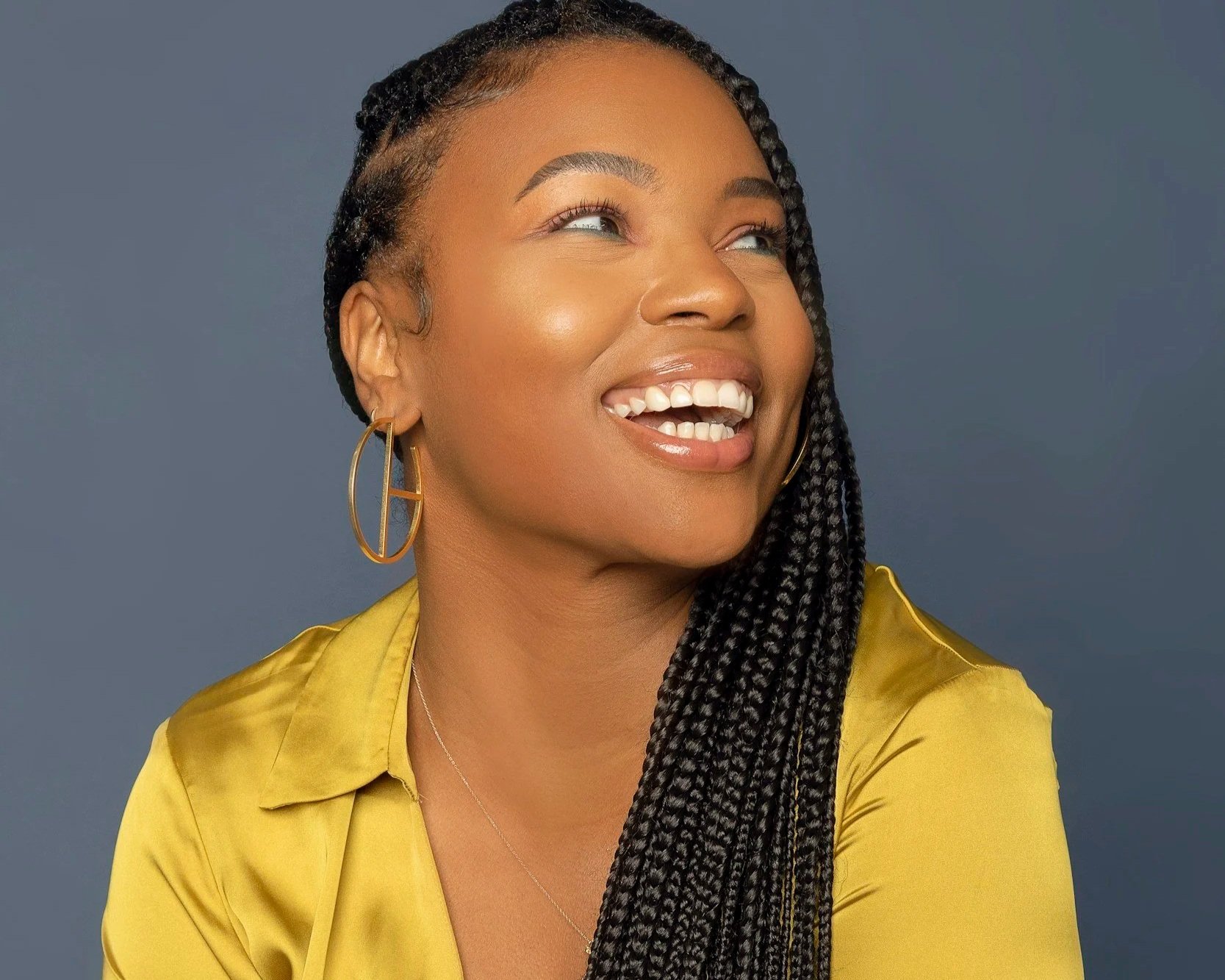 Black mom with box braids posing for a photo