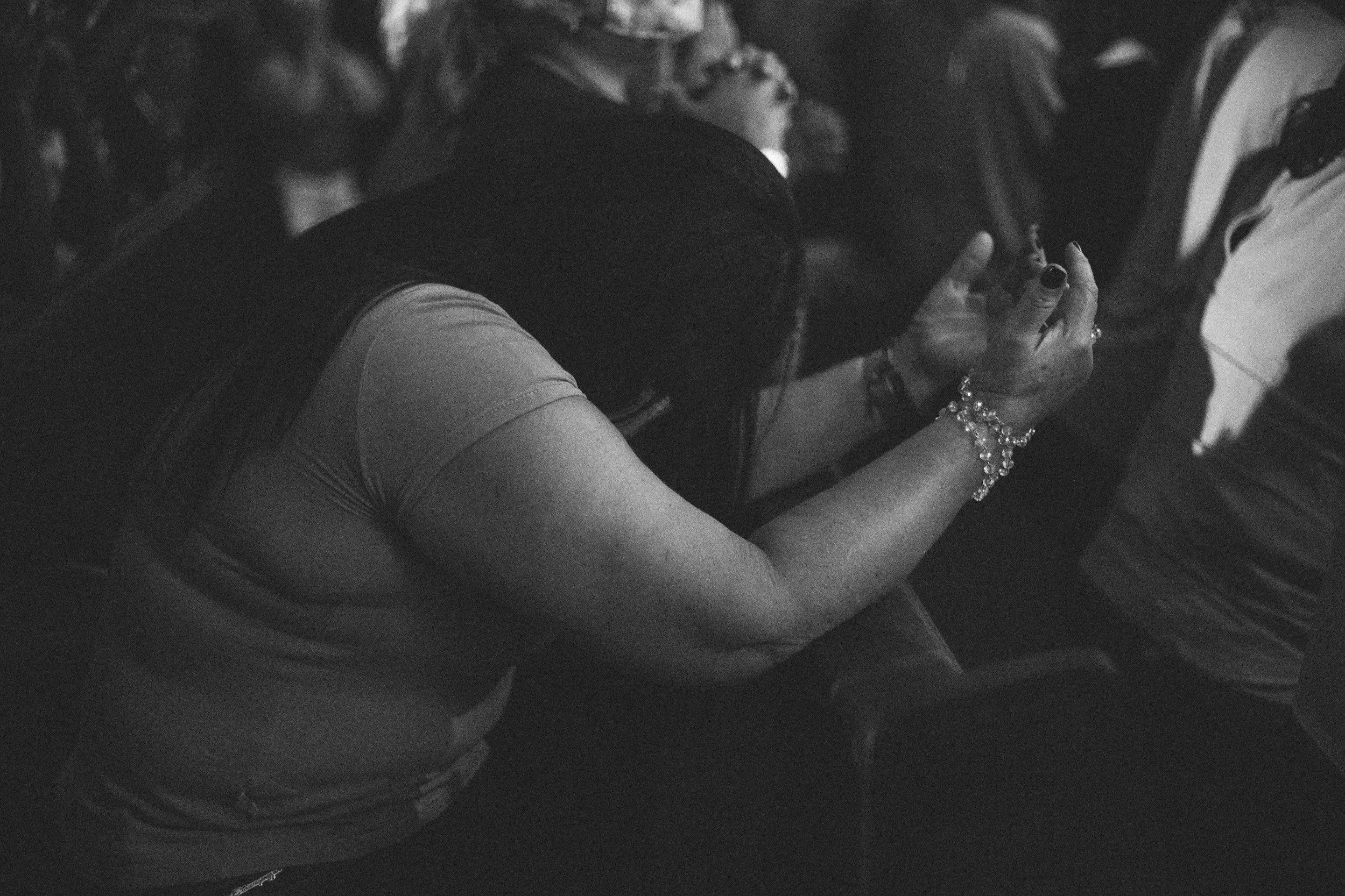 Woman bowing down in worship.