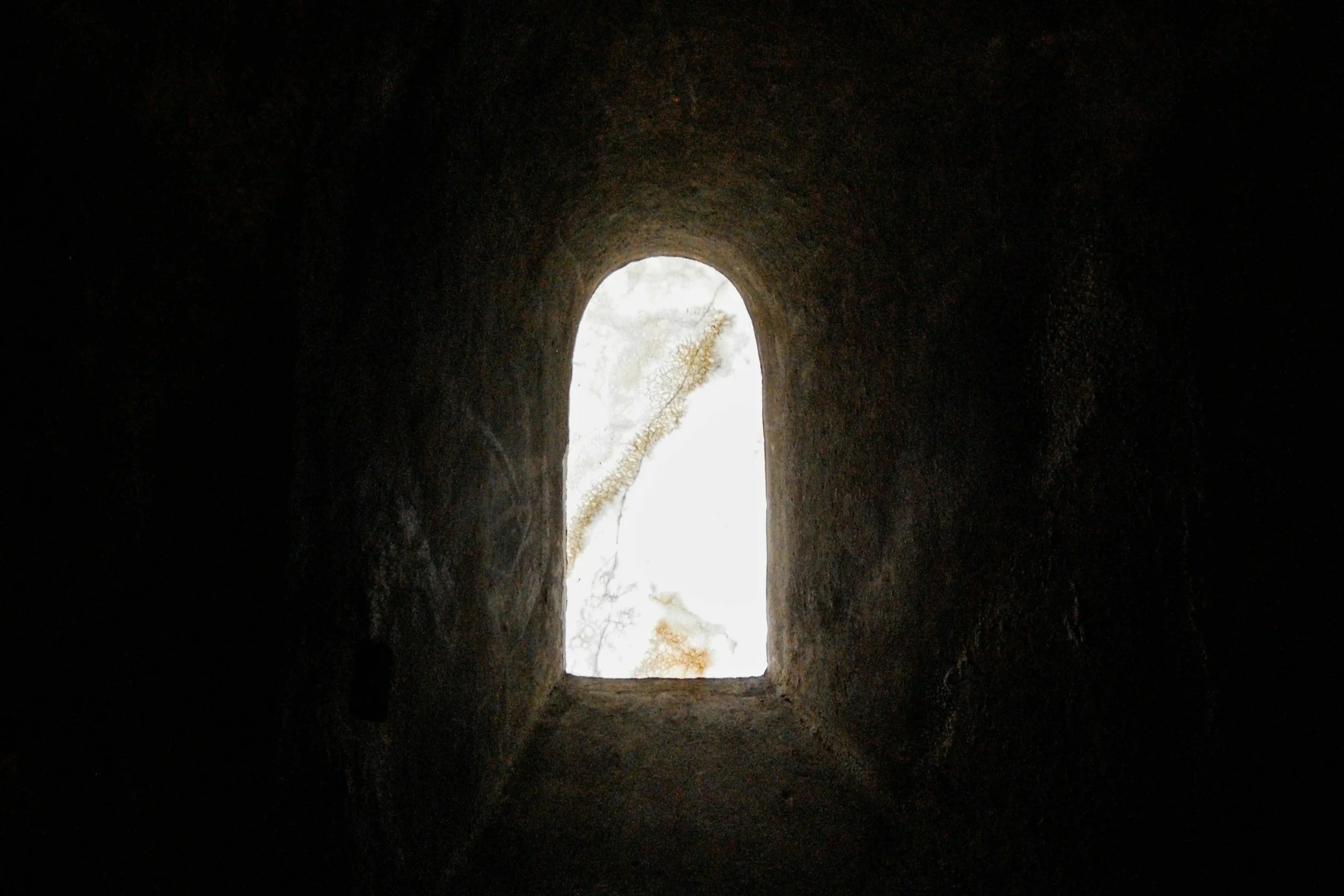 Empty tomb with light shining at the entrance