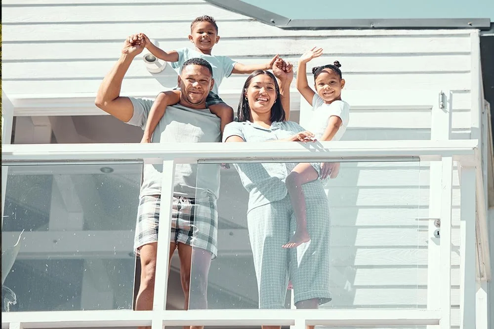 Newmarket, Ontario family standing behind aluminum railings by Allure Glass.