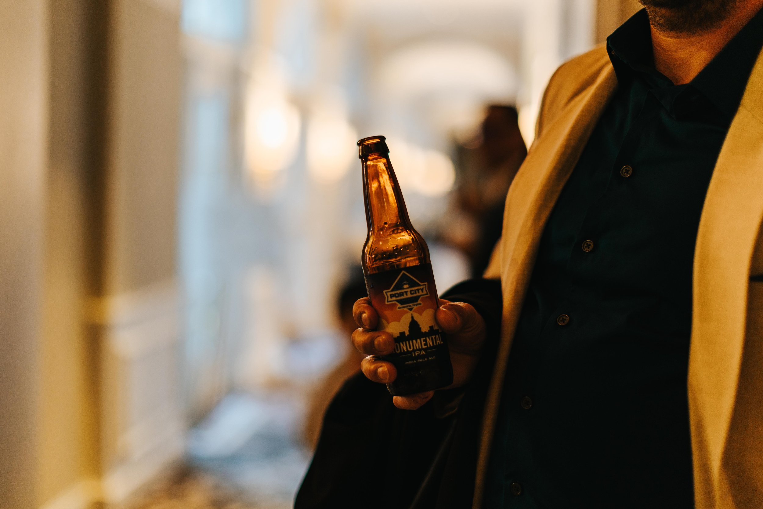 guests held beer bottle on wedding