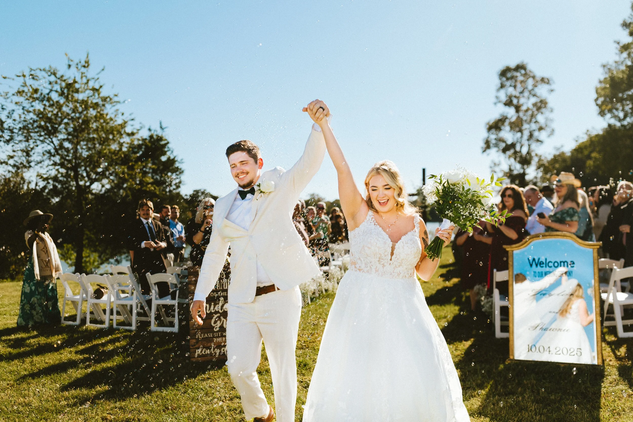 Shawnie and Taylor cheering joyfully during wedding recessional, documentary wedding photography by Love Story By Aira