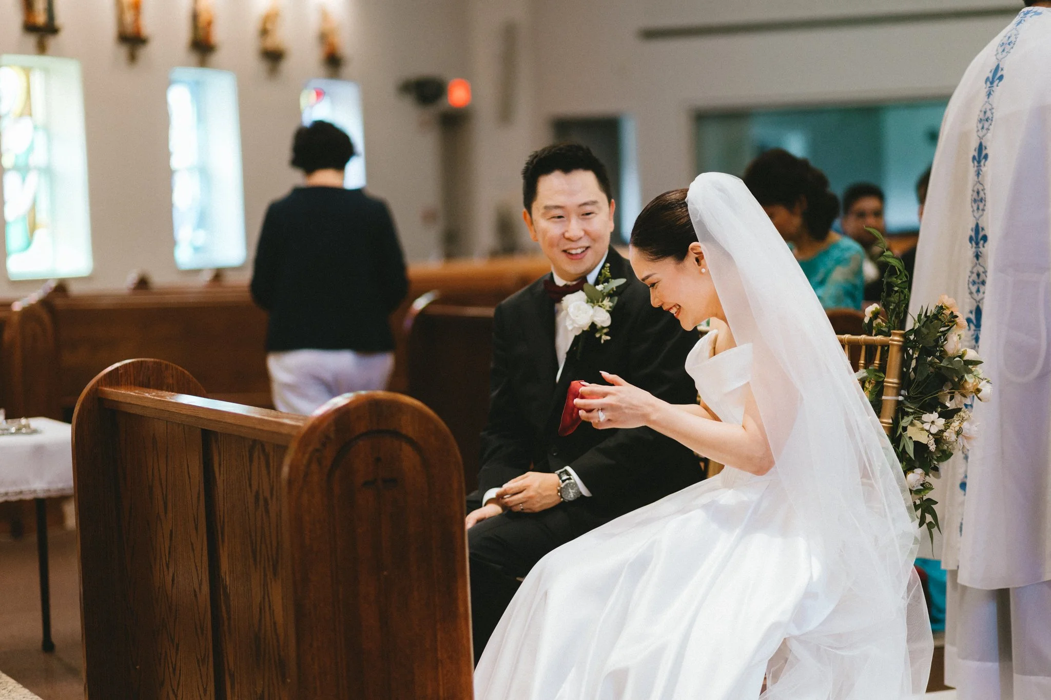 Couple exchanging rings during church wedding ceremony
