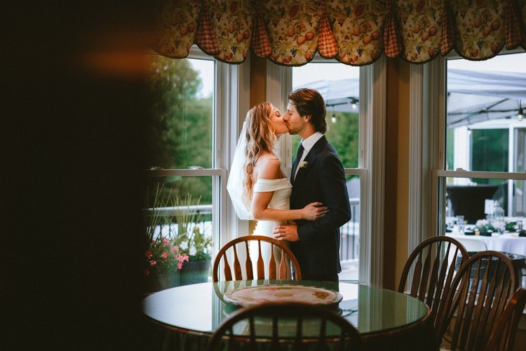bride and groom kissing in their Maryland home