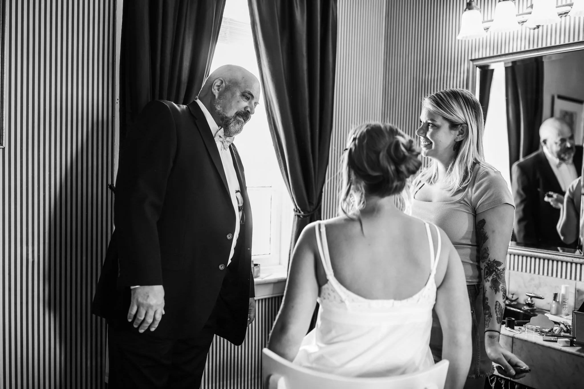 Father seeing his daughter in her wedding dress for the first time during getting ready, emotional documentary wedding moment captured